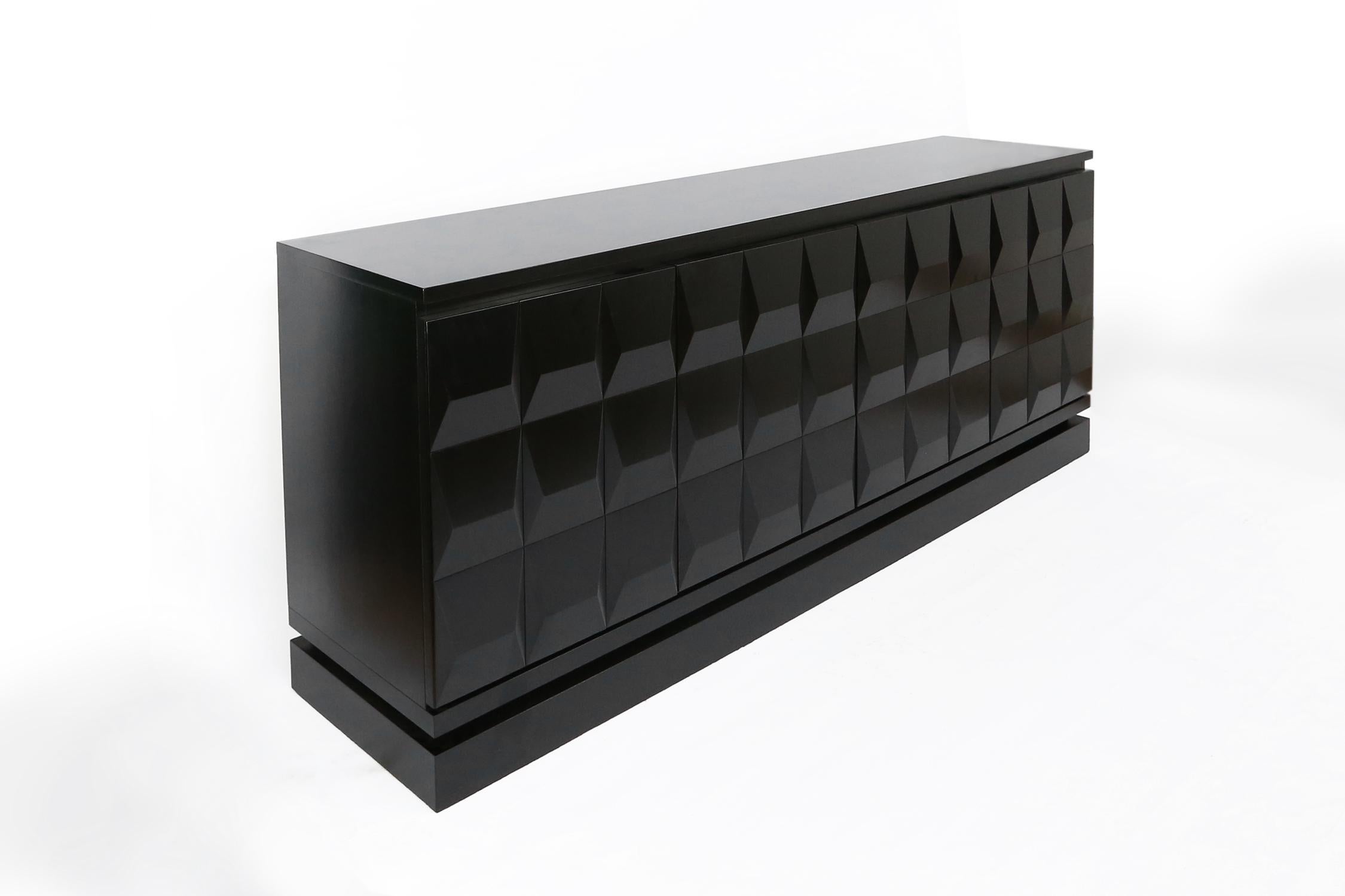 Impressive brutalist sideboard made in the seventies in Belgium. 
This cabinet has a beautiful graphic pattern and was made in solid ebonized black lacquered mahogany. The high quality wood, symetric design and pattern add to the brutalist