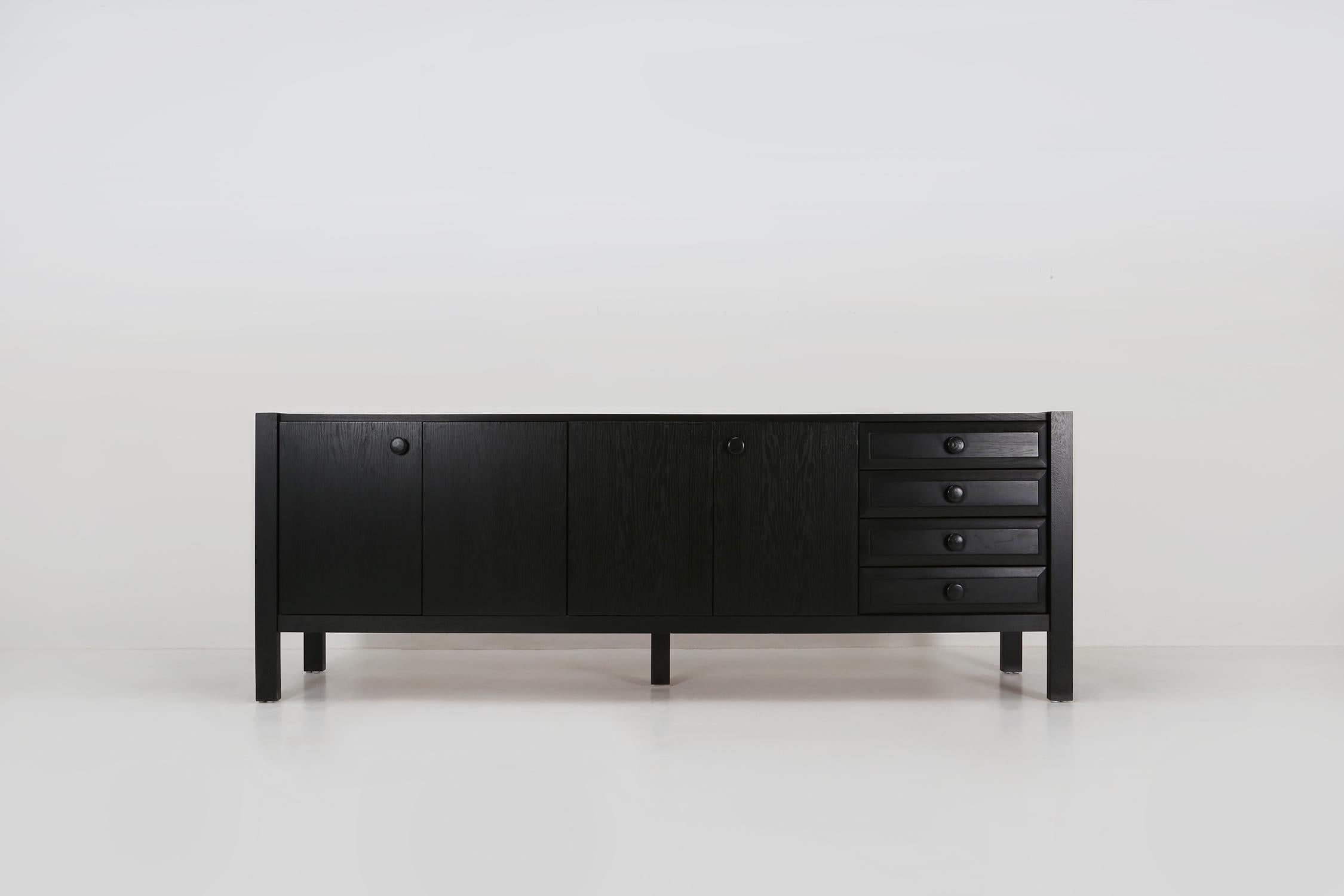 Belgian sideboard, black colored wood, Belgium, 1980s.

This grand Belgian sideboard is a real eye-catcher. The design is minimalistic with excellent woodworking. This large sideboard has a timeless design with 4 straight doors and 4 drawers on