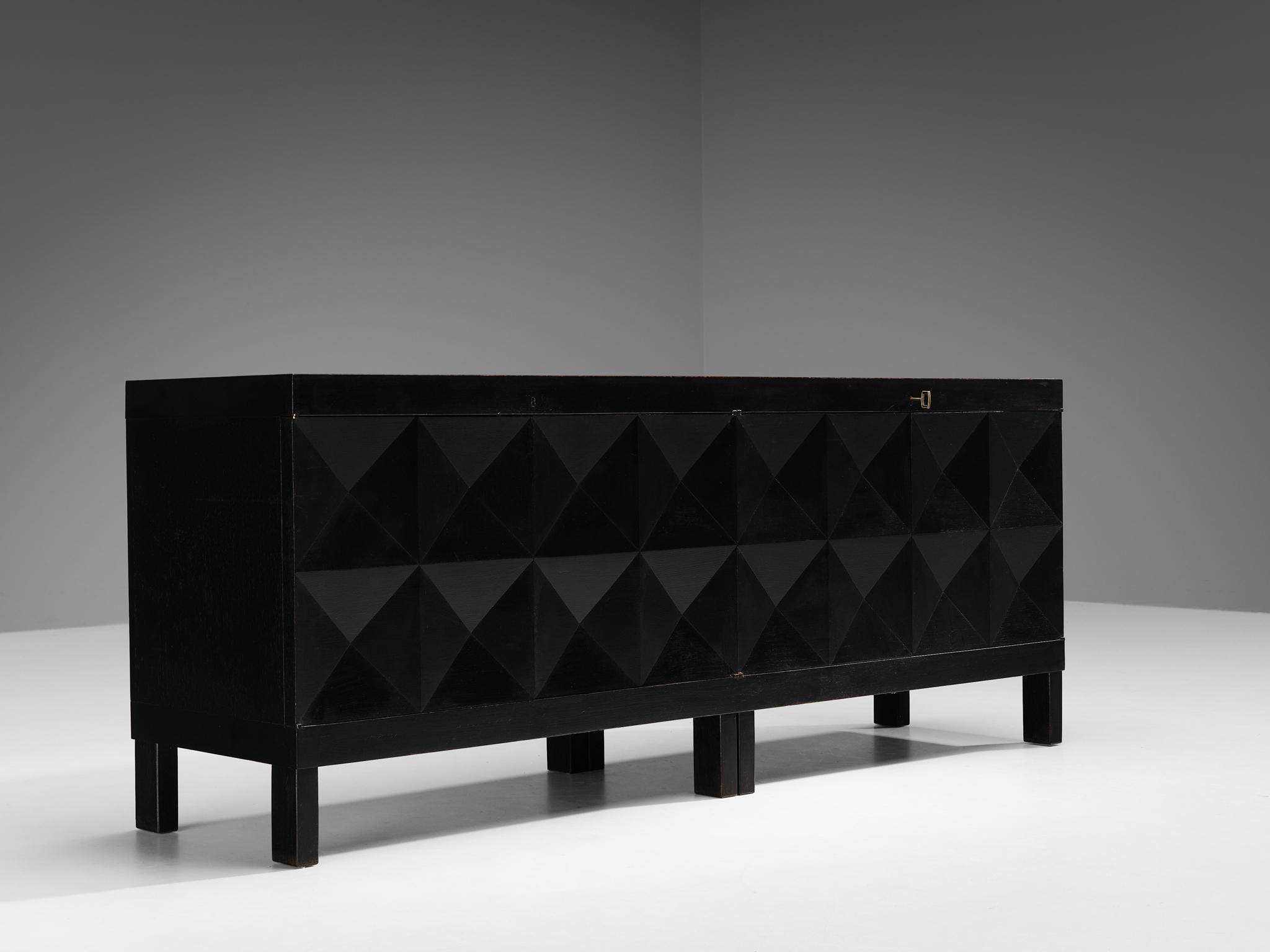 Sideboard, lacquered oak, brass, Belgium, 1970s. 

This graphic sideboard features a clear rhythm and flow established by means of a well-thought-out lay out that is utterly well-balanced. The carved geometric lines on the door panels immediately
