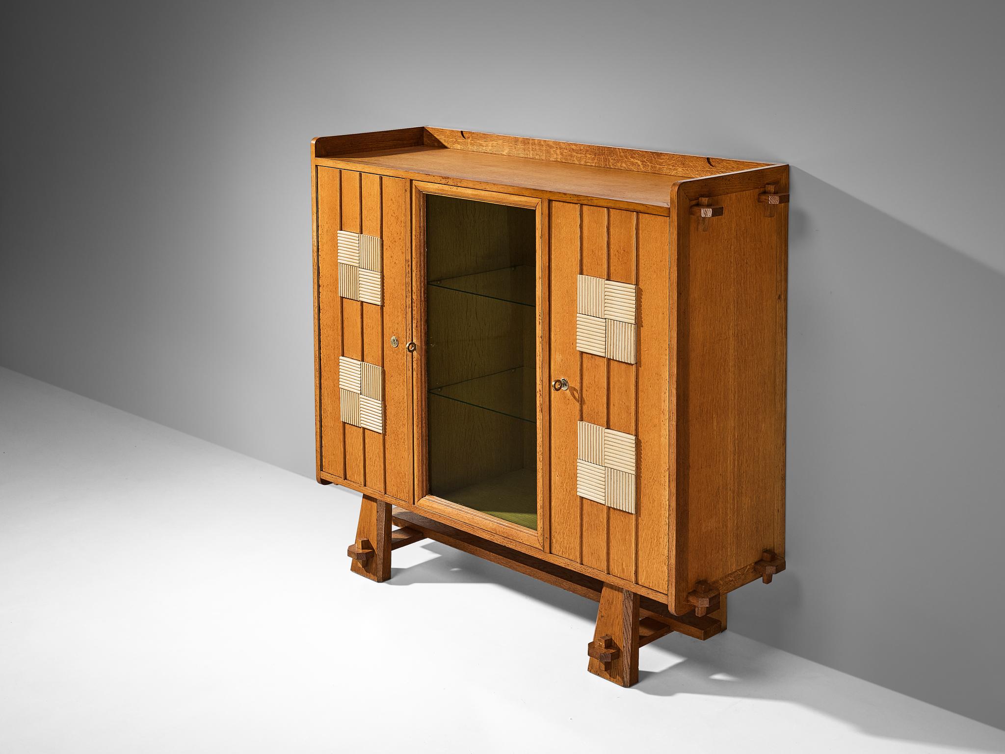 Cupboard, oak, glass, brass, aluminum, Belgium, 1970s. 

This very expressive cupboard features a clear rhythm and flow that has been achieved through a thoughtful layout that is perfectly balanced. The off-white lacquered squares with relief