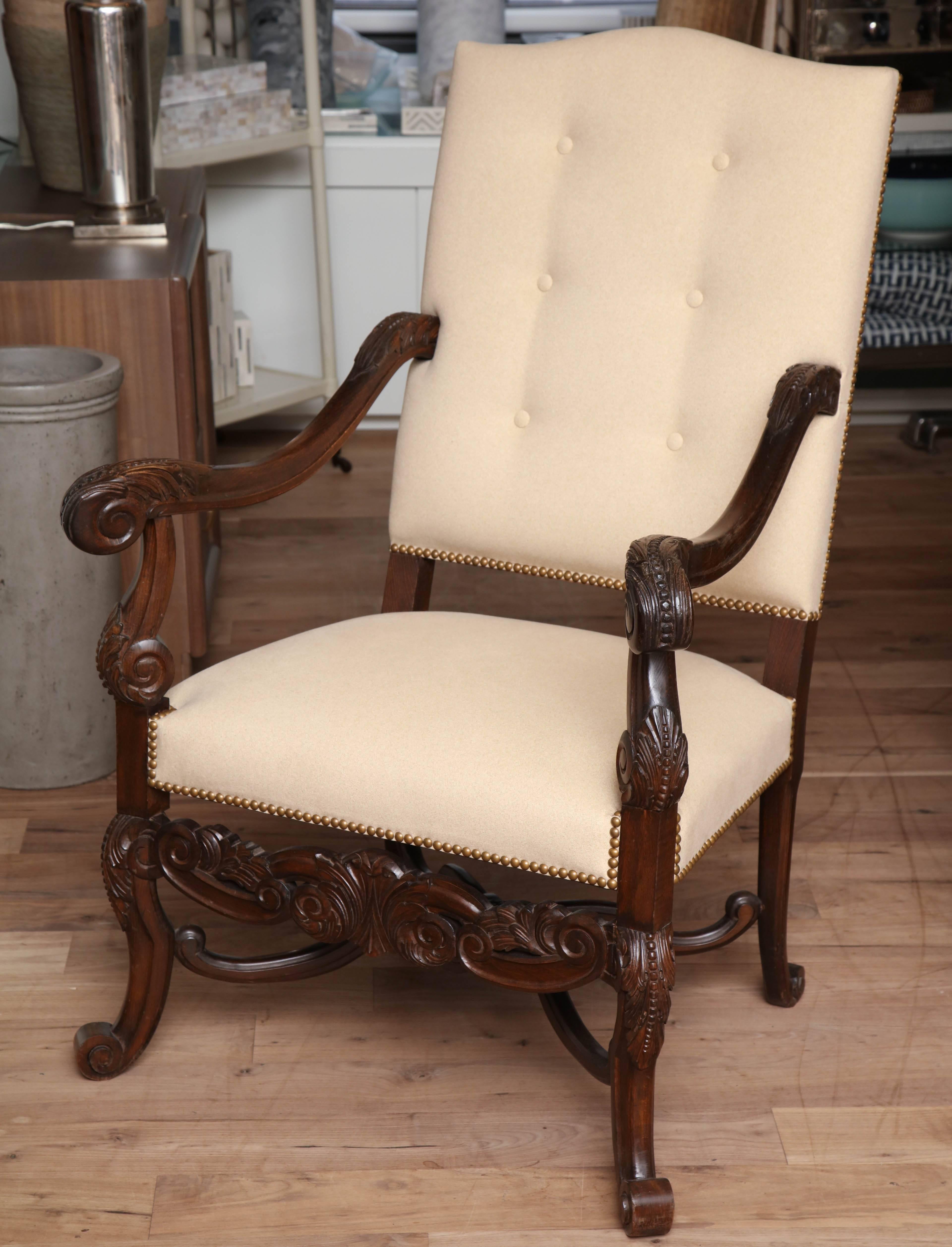 Hand-carved 19th century armchair from Belgium upholstered in flannel suede with tufted back and French natural nailhead trim.