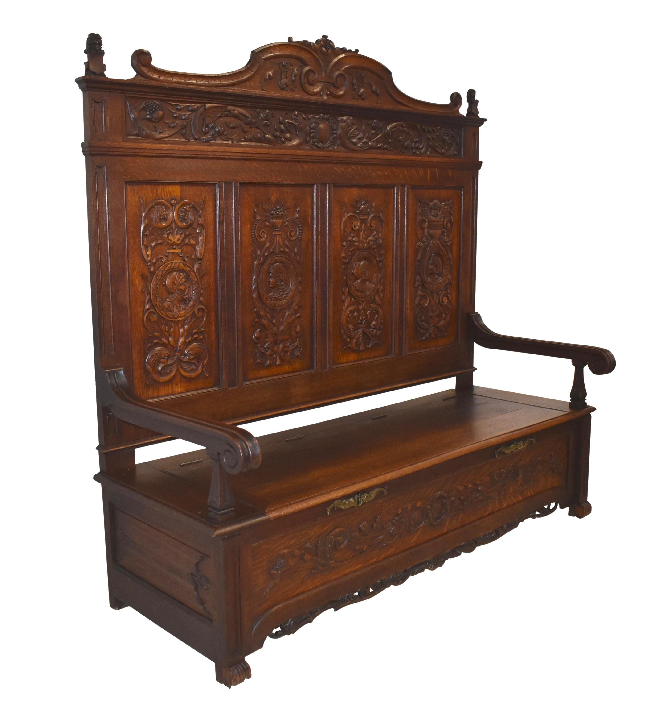 Showcasing the pattern of flecking and tight grain unique to quartersawn oak, this beautiful bench features elaborate carvings typical of late 19th century Belgium furniture. Its high back is carved with the profile of one character on each of its