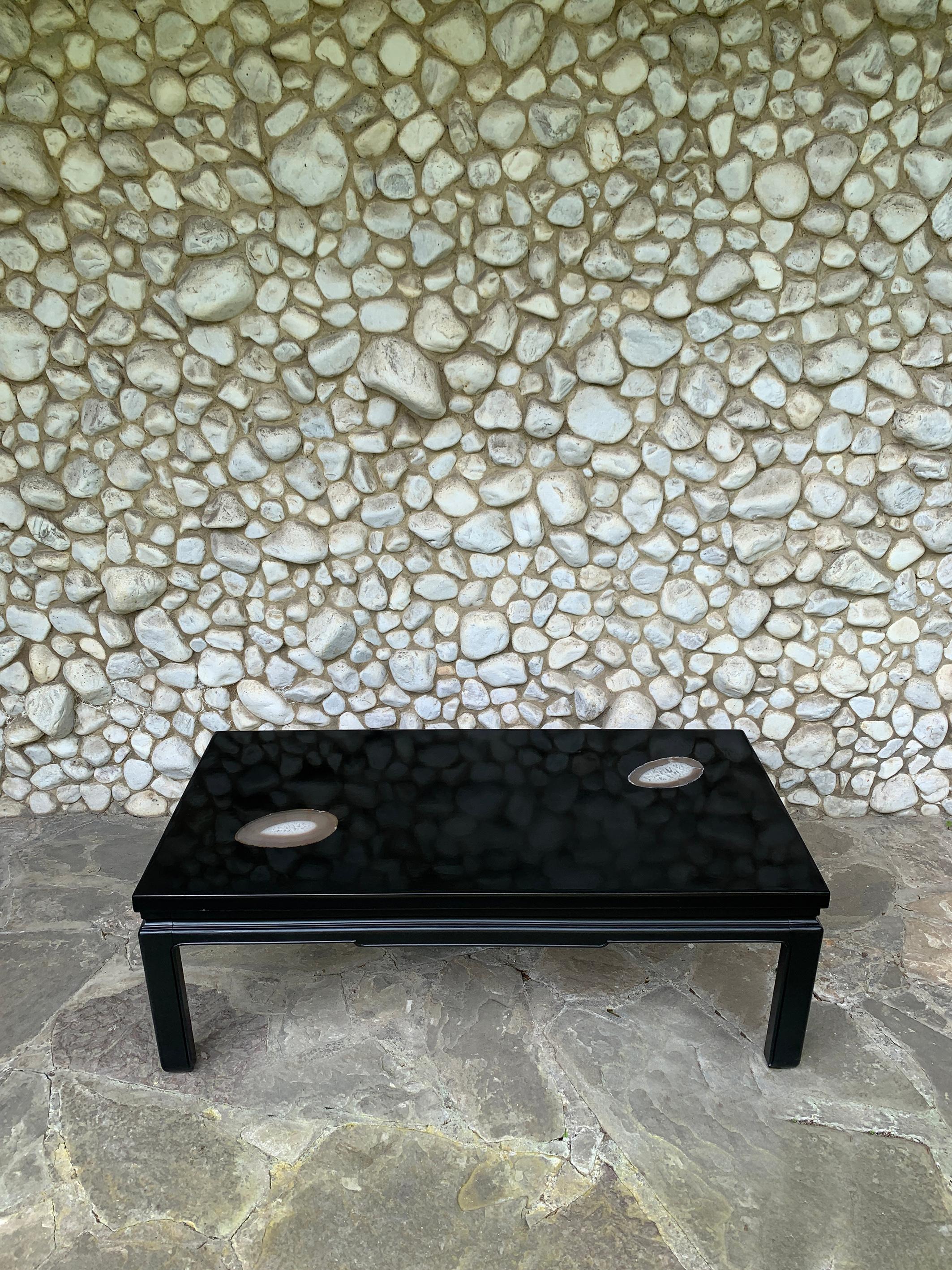 Coffee table in black resin and agates - created in Belgium during the 1970

Top in black tinted resin on a natural stone base, with two agate stones inlaid. Painted wooden base.

Belgian design, unknown creator. At that time, a series of designers