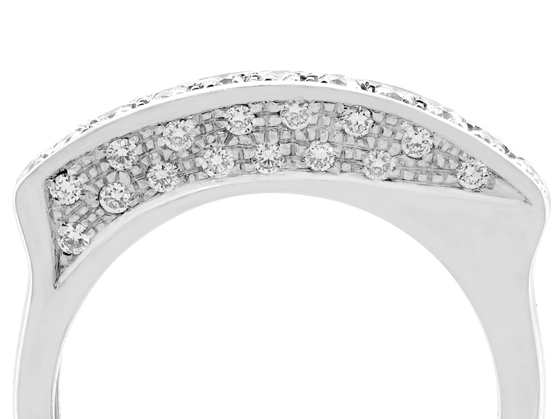 An unusual 0.85 carat diamond and 18 karat white gold half eternity ring; part of our diverse diamond jewelry and estate jewelry collections.

This fine and impressive unusual half eternity ring has been crafted in 18k white gold.

The asymmetric