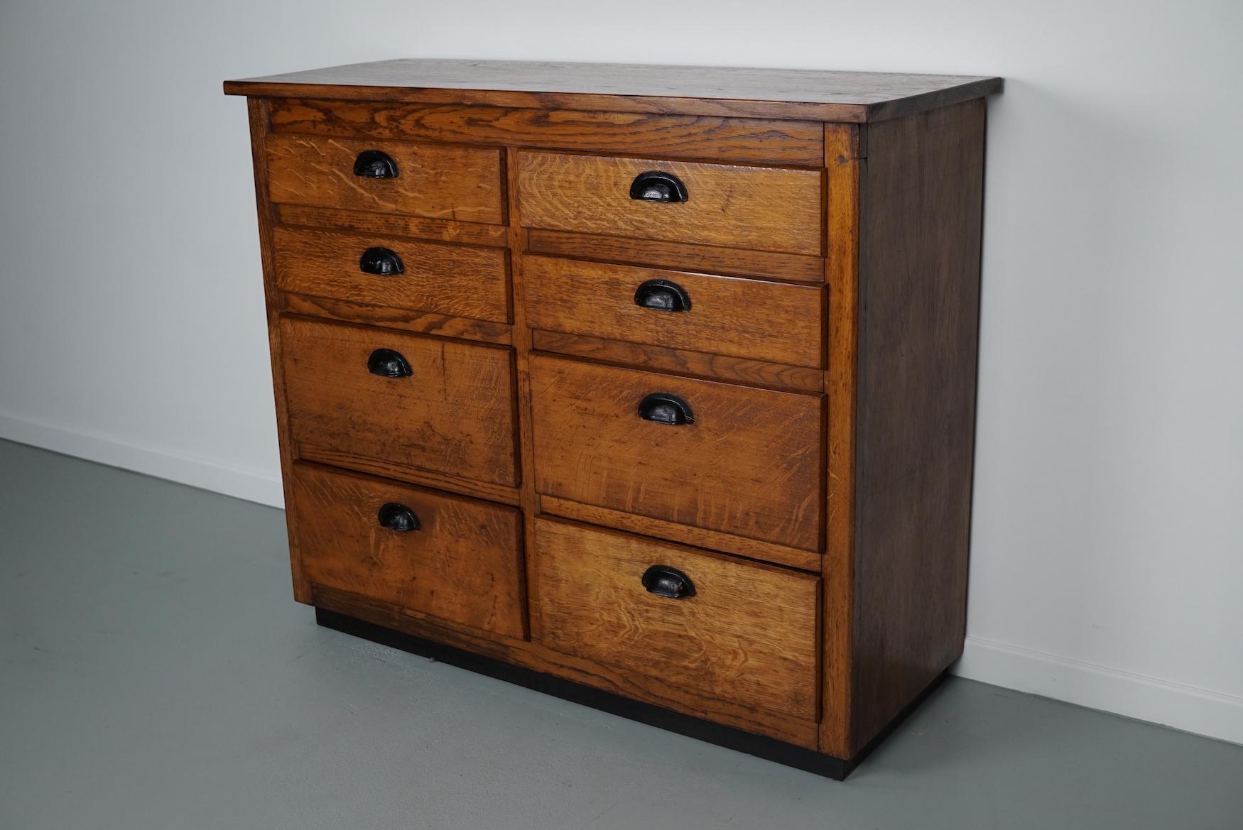 This apothecary cabinet was made circa 1940s in Belgium and was used in a hardware store in Belgium until recently. It features many drawers in 2 different sizes with black metal handles. The interior dimensions of the drawers are: D 35 x W 45 x H 9