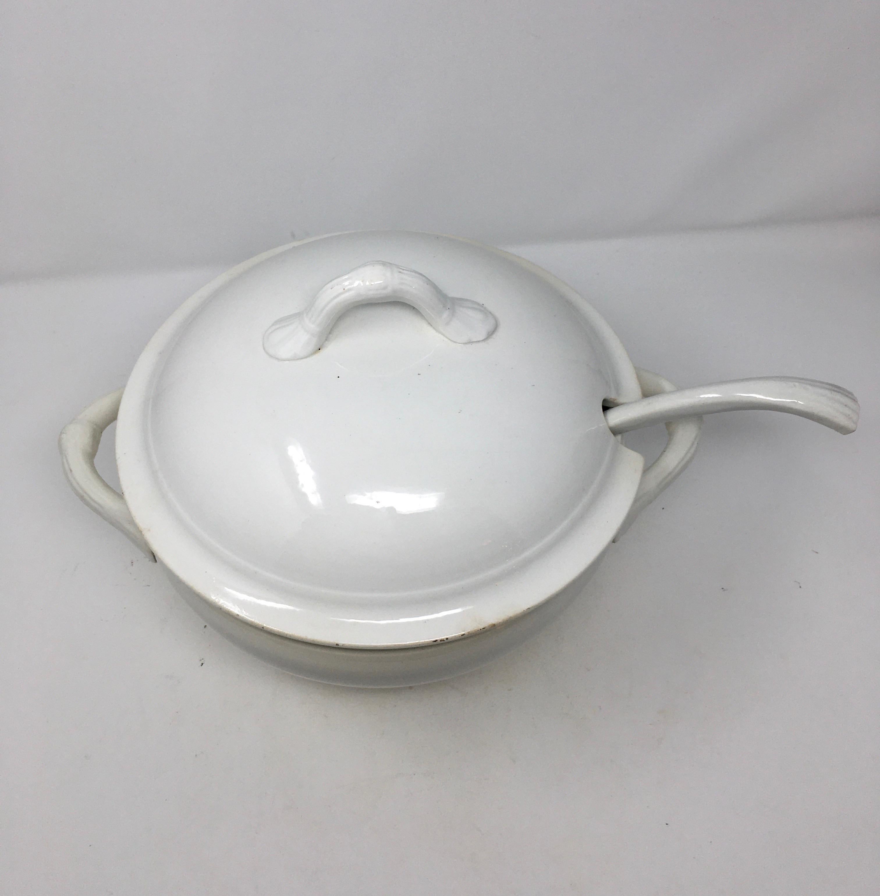 This is a Belgian ironstone tureen, with lid and ladle from the late 19th century. It is marked Manufacture Imperiale et Royale, Nimy, Fabrication Belge, Made in Belgium. The bowl was produced in the late 1800s-early 1900s in Belgium. This company