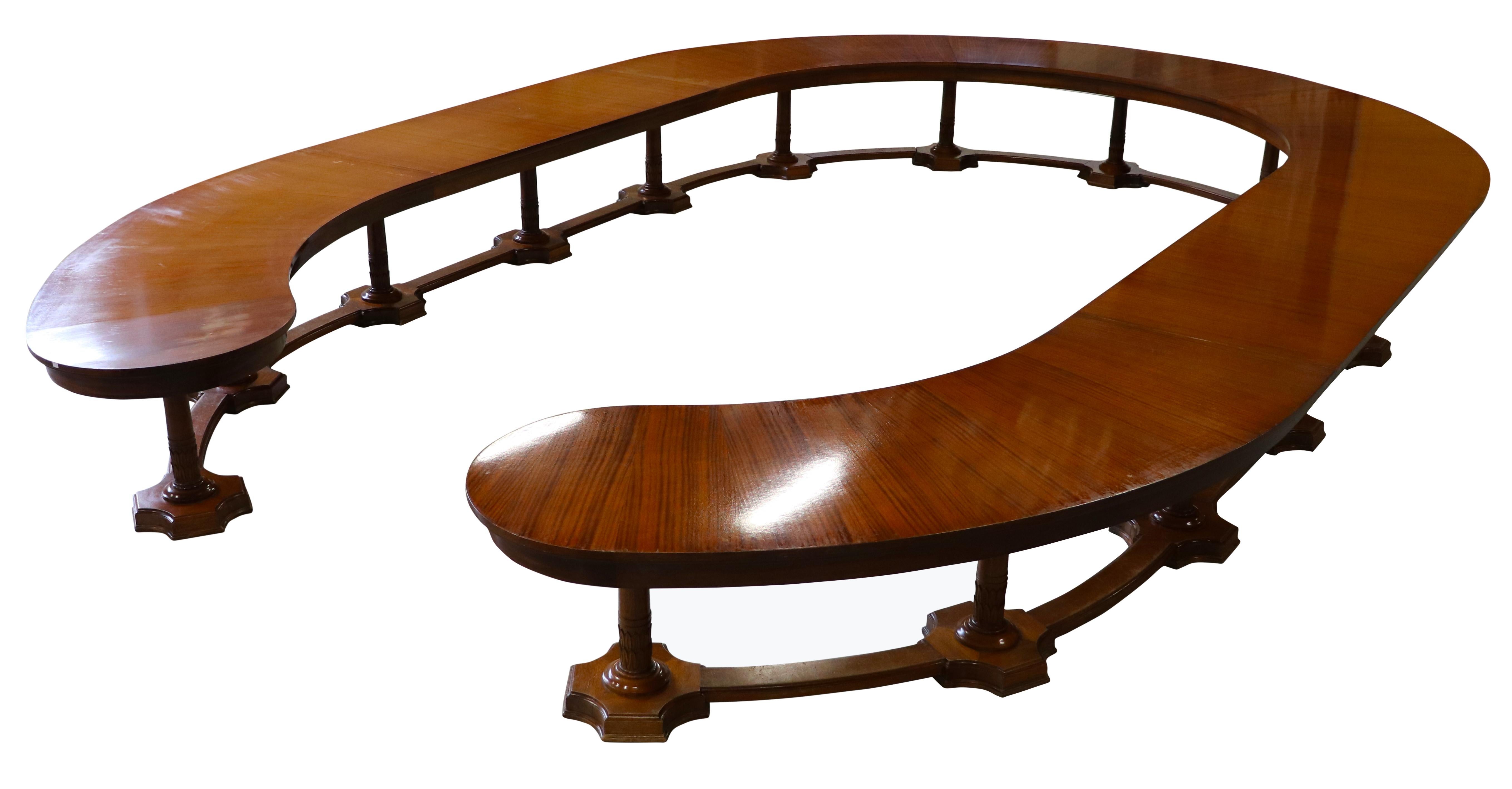 An amazing and breathtaking council table, conference table, boardroom table made in Belgium circa 1920 in the Neo-Classical style. Beautiful figured mahogany (in need of refreshing) horseshoe shaped tabletop resting on tapered columnar gun barrel