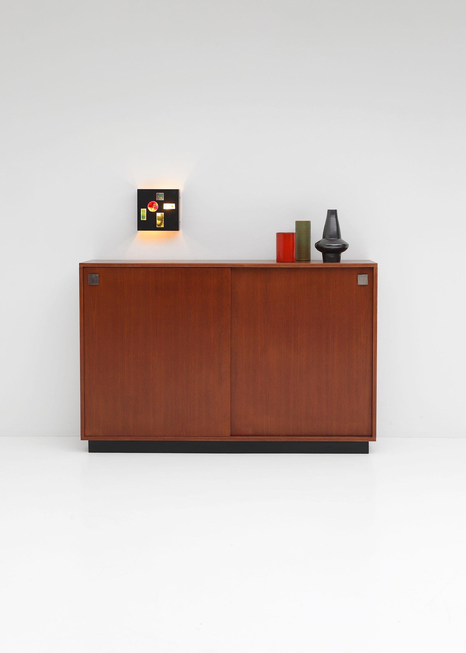 Alfred Hendrickx, Mid-Century Modern, teak, Belform, Belgium, 1960s

This cabinet was designed by Alfred Hendrickx for Belform in the 1960s. It has two sliding doors and offers a lot of storage space due the shelves inside. The cabinet is fully