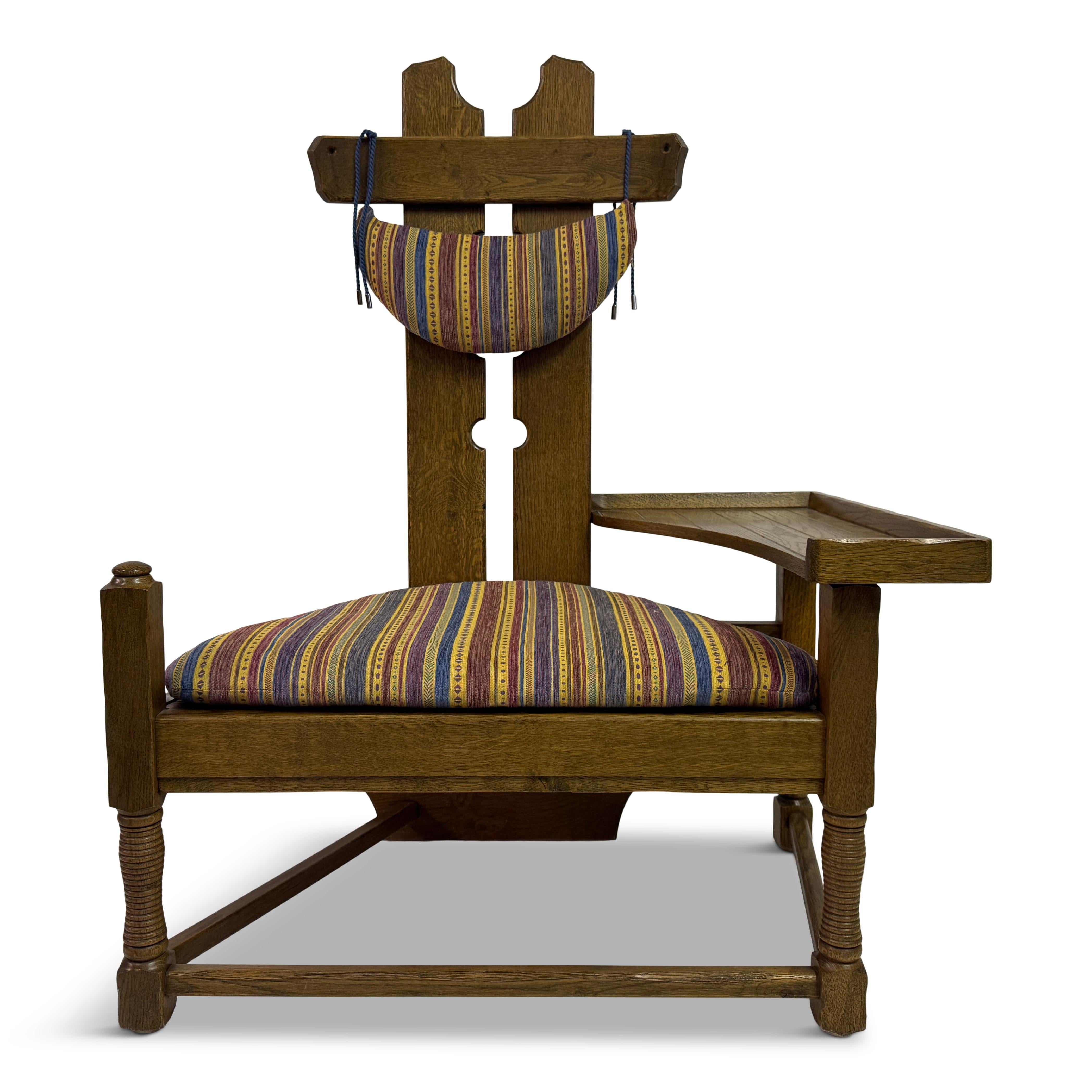 Dutch Oak Armchair with Integrated Side Rest, 1960s


A sculptural oak armchair of Dutch origin, dating to the 1960s. The design is strikingly architectural, with a tall backrest pierced at the centre and finished with a detachable half-moon head