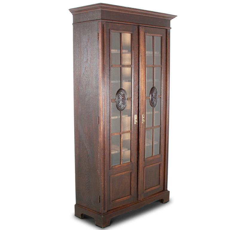 A Belgian oak, two-door bookcase, the doors with thick bevelled glass panels and carved central medallions. A definite Arts & Crafts/Art Deco influence, circa 1920-1930.



 