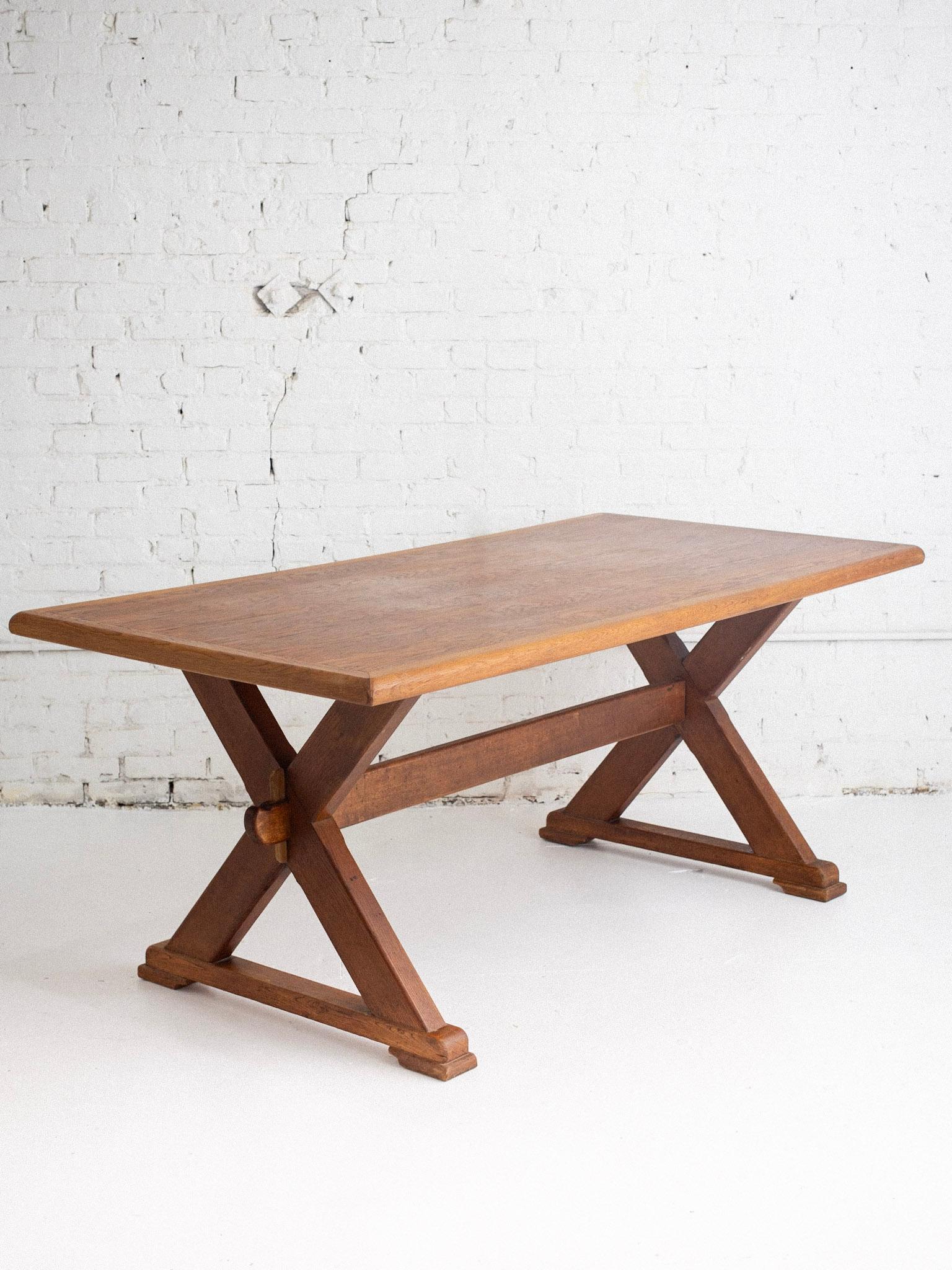 A mid century oak farmhouse dining table. “X” trestle base. Sourced in Belgium.