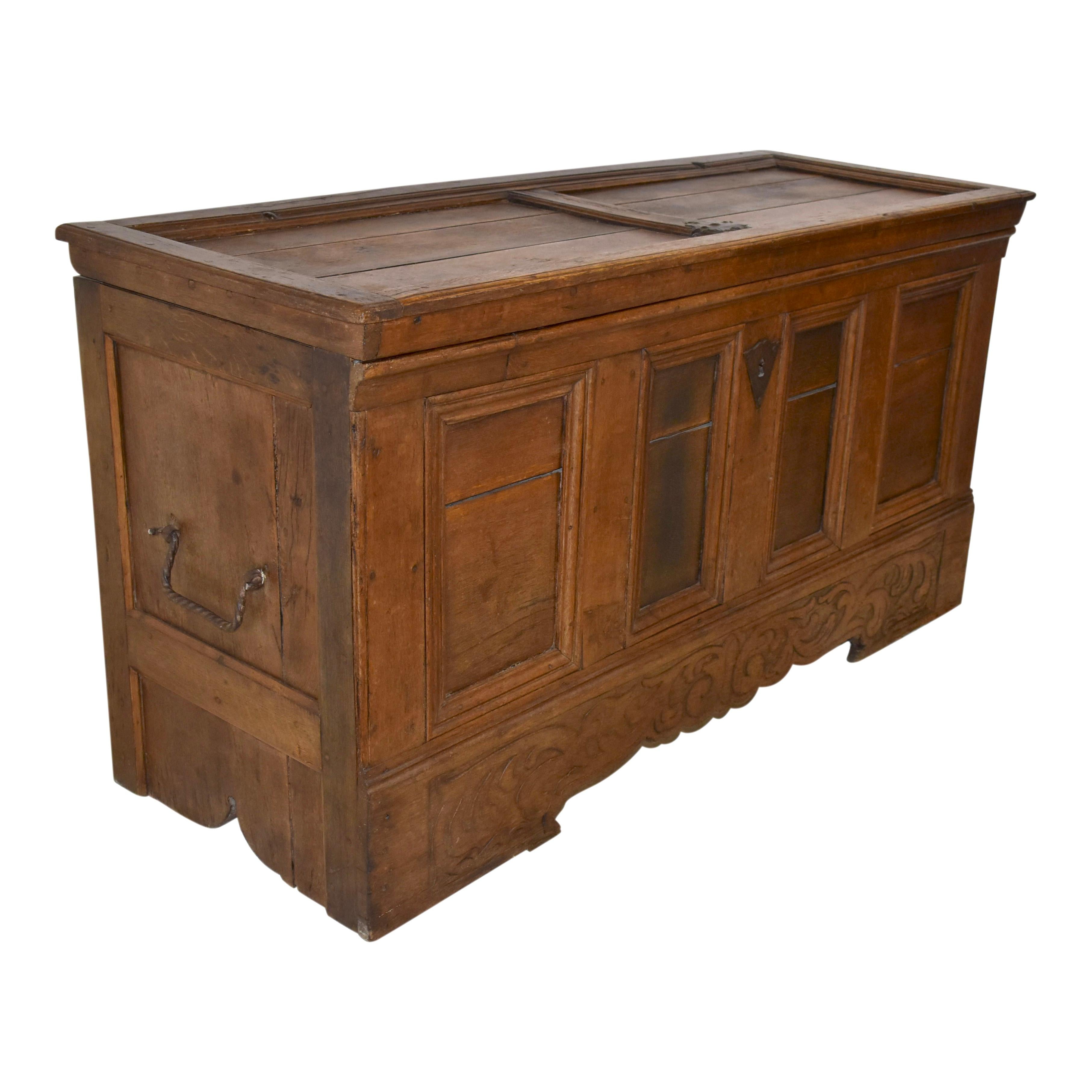 Crafted from European Oak and finished with a light stain, this substantial trunk boasts generous storage and solid construction. The trunk features a recessed plank top and recessed panels on the sides and front. A carved apron below the four front
