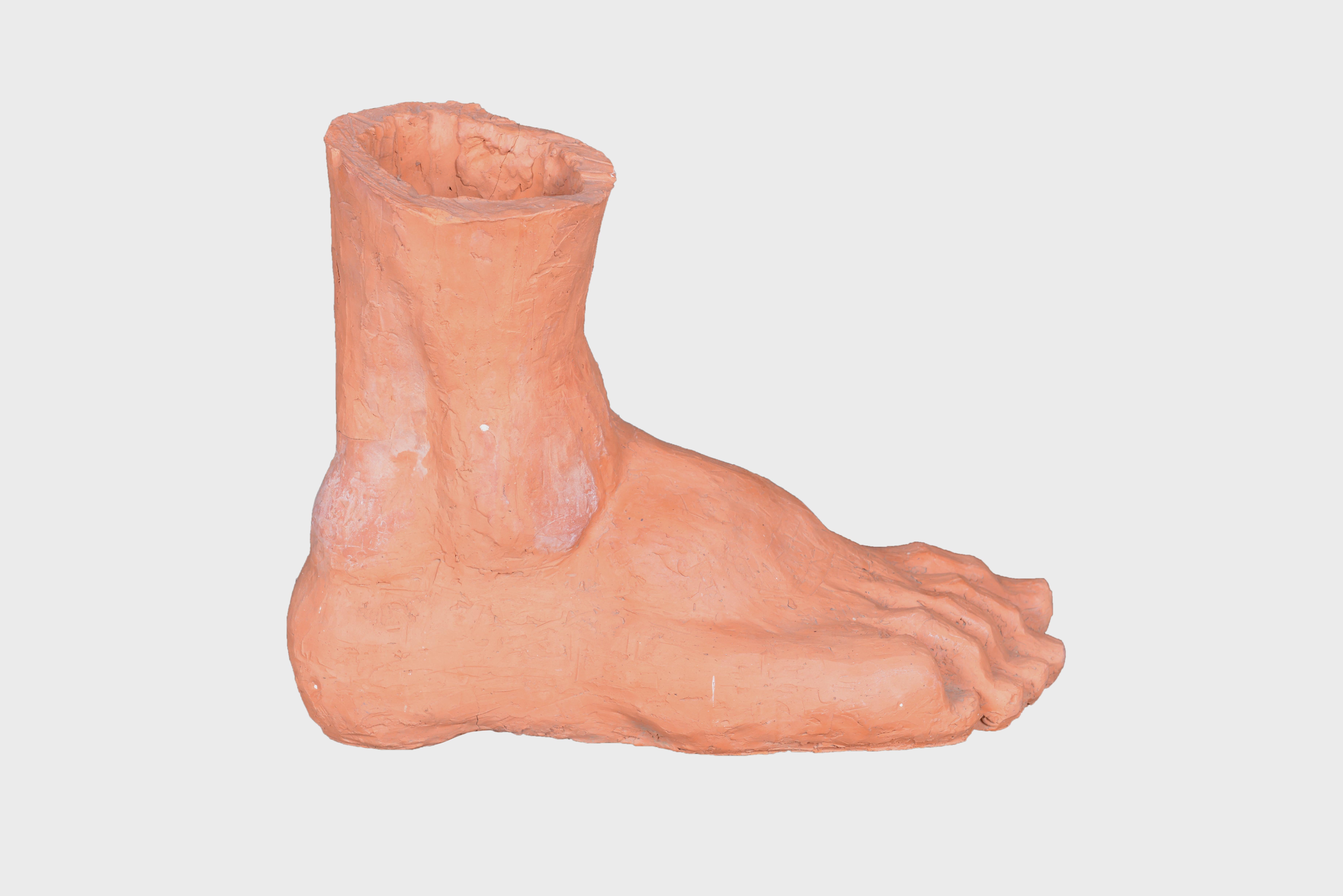 An oversized terracotta foot modelled in the classical Greco-Roman taste.