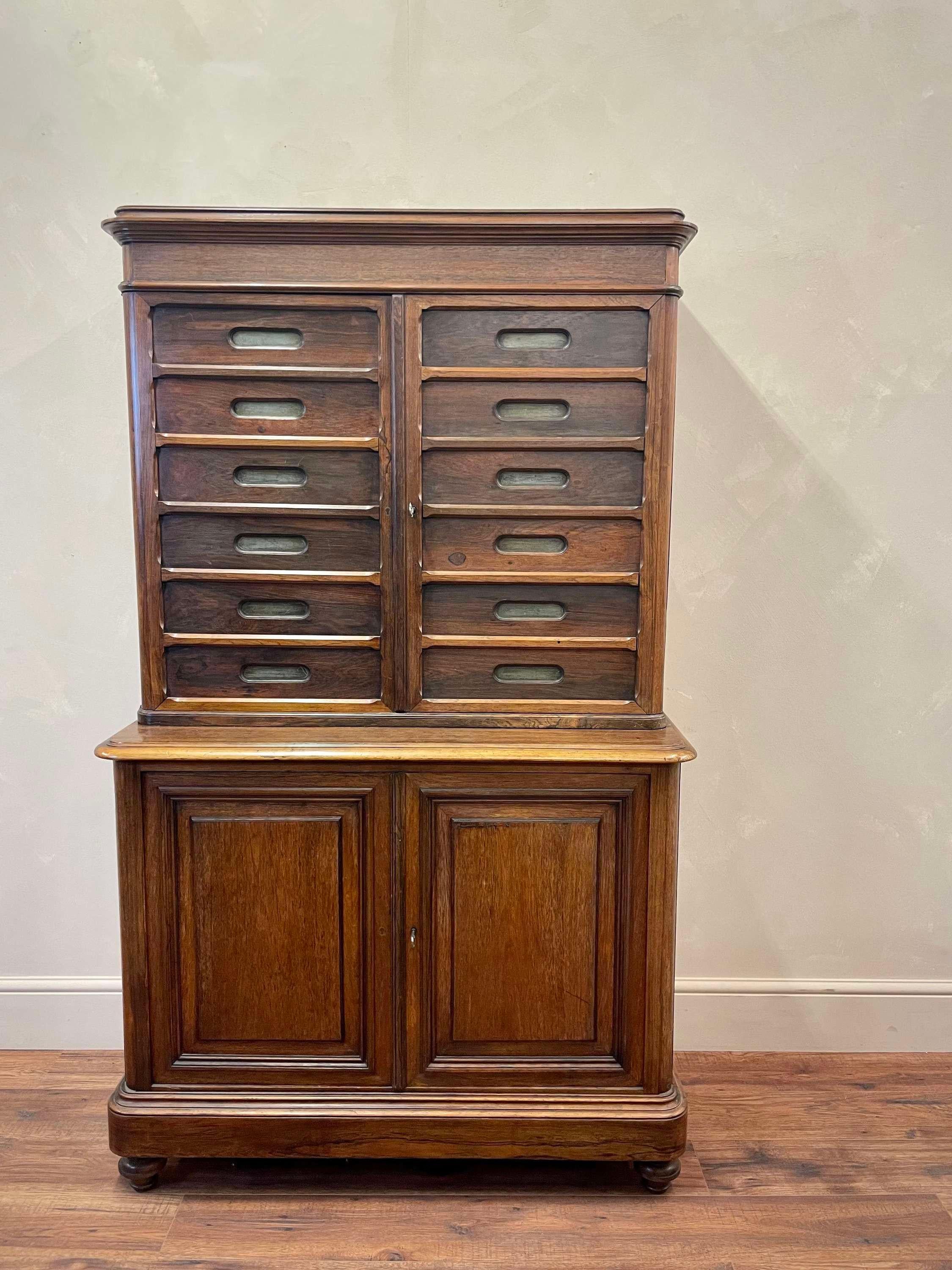 Smart set of Belgian postal/office mahogany / pine pigeon holes.
With 12 upper pigeon holes above a shelved cupboard below.
Working lock.
Clean and solid.
Great for office storage or even plates for a kitchen
Dimensions:W: 106cm (41.7