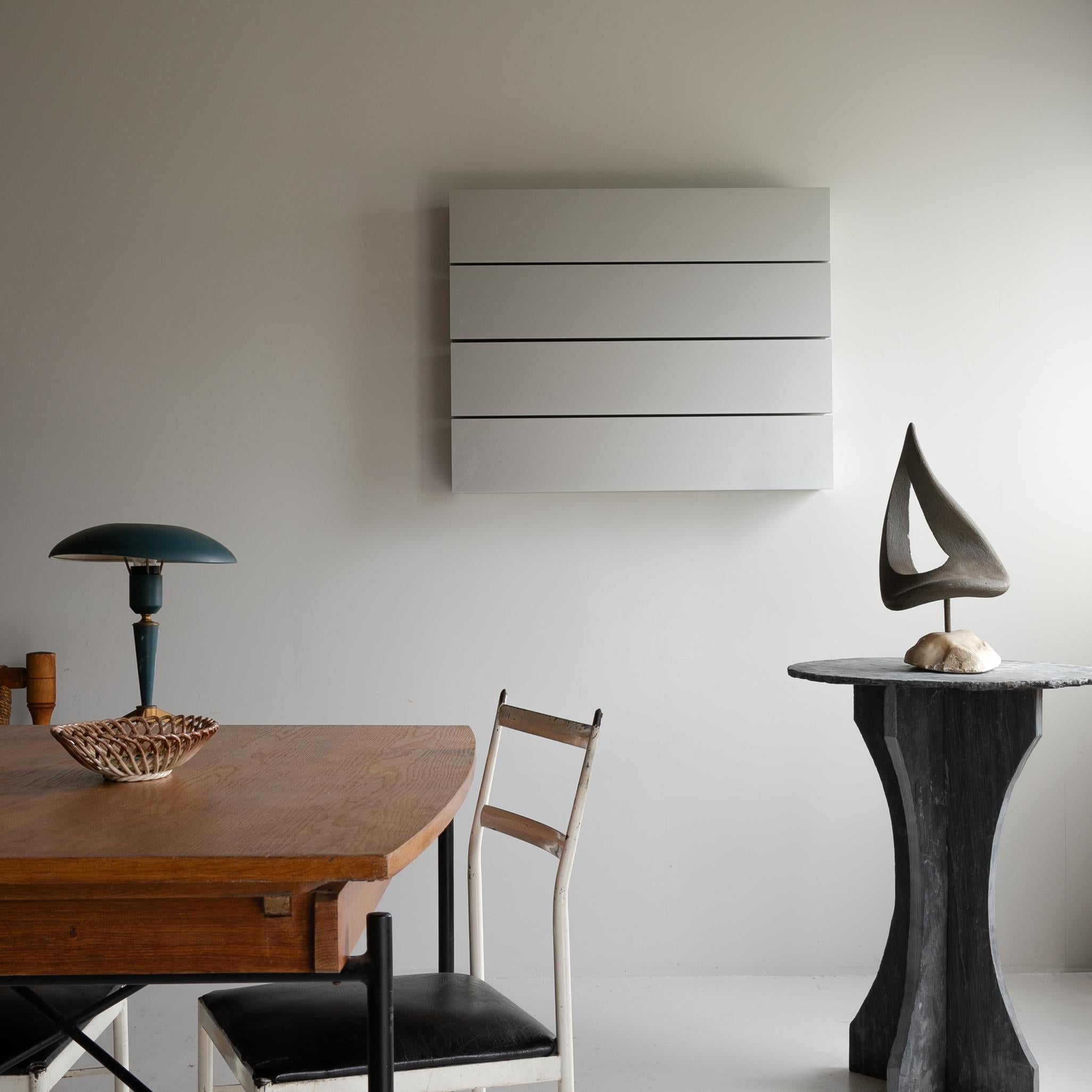 A round slate side table made in Belgium, set upon a two-part shaped slate base.

This item evokes the spirit of wabi-sabi, the Japanese philosophy of finding beauty in imperfection and impermanence.

It represents a beauty that is the opposite of