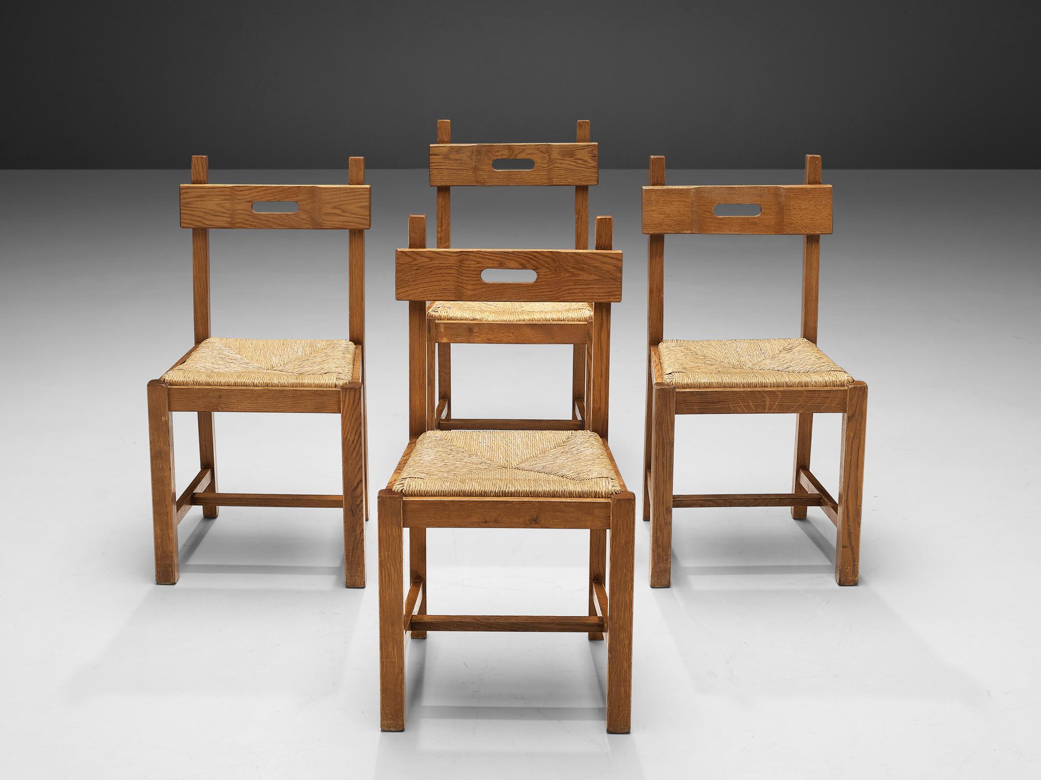 Set of four dining chairs, oak, straw, Belgium, 1960s.

These chairs are executed in oak which has gained a rich patina over time and a seat of straw. The chairs have a very solid and geometrical backrest. The chairs are both functional and clear in