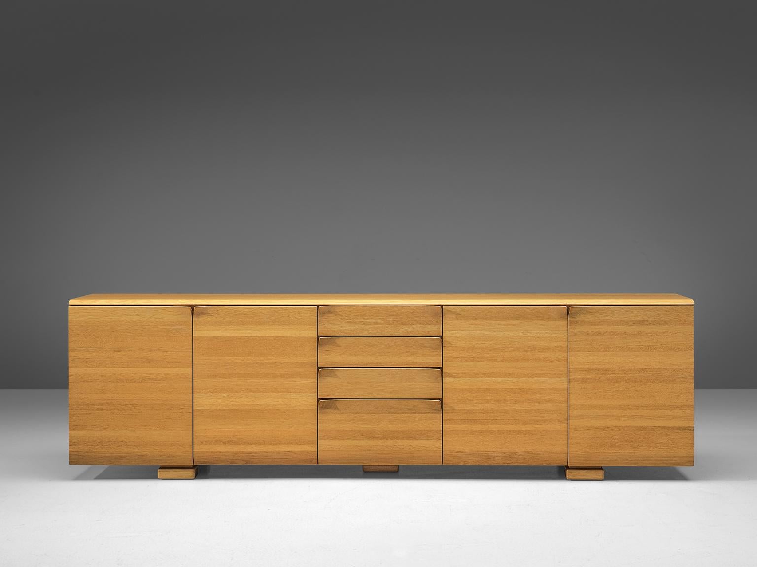 Sideboard by Van Den Berghe - Pauvers, elm, Belgium, 1970s.

Minimalistic sideboard that is very well designed. This Belgian credenza features doors and drawers with striking handles. The doors flow over in the handles, which create a similar idea