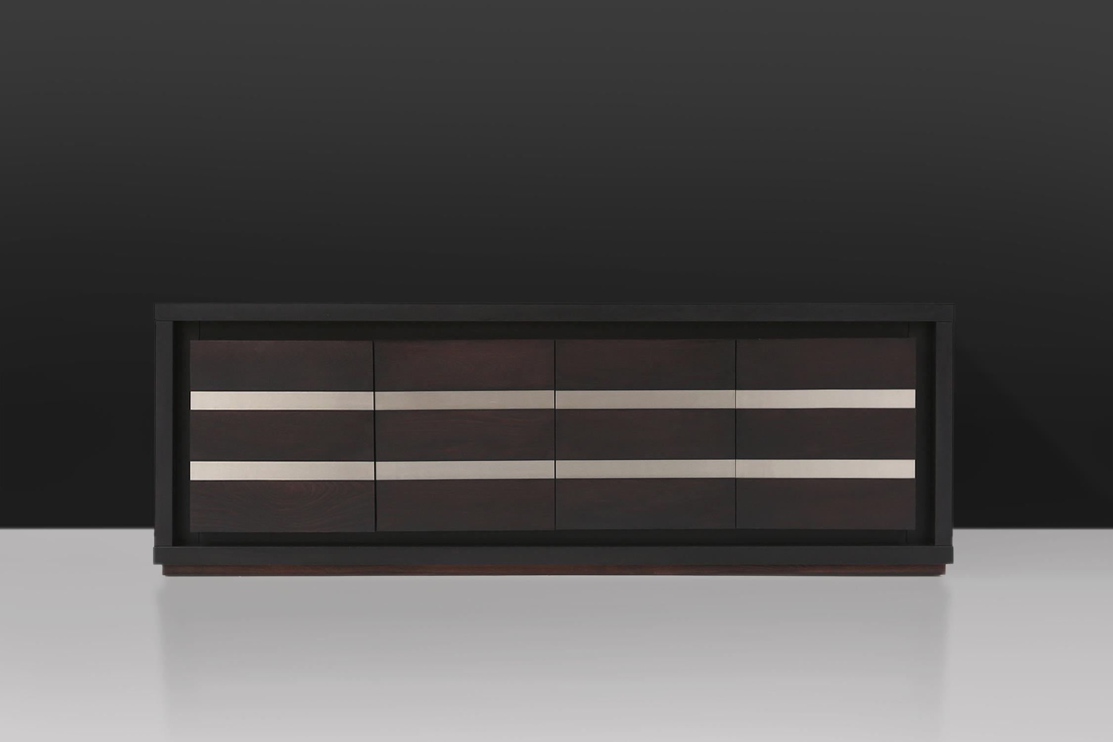 Belgian sideboard made of black oak.
This high quality credenza has 4 door panels with two aluminium strips. The shelves can be adjust in height.