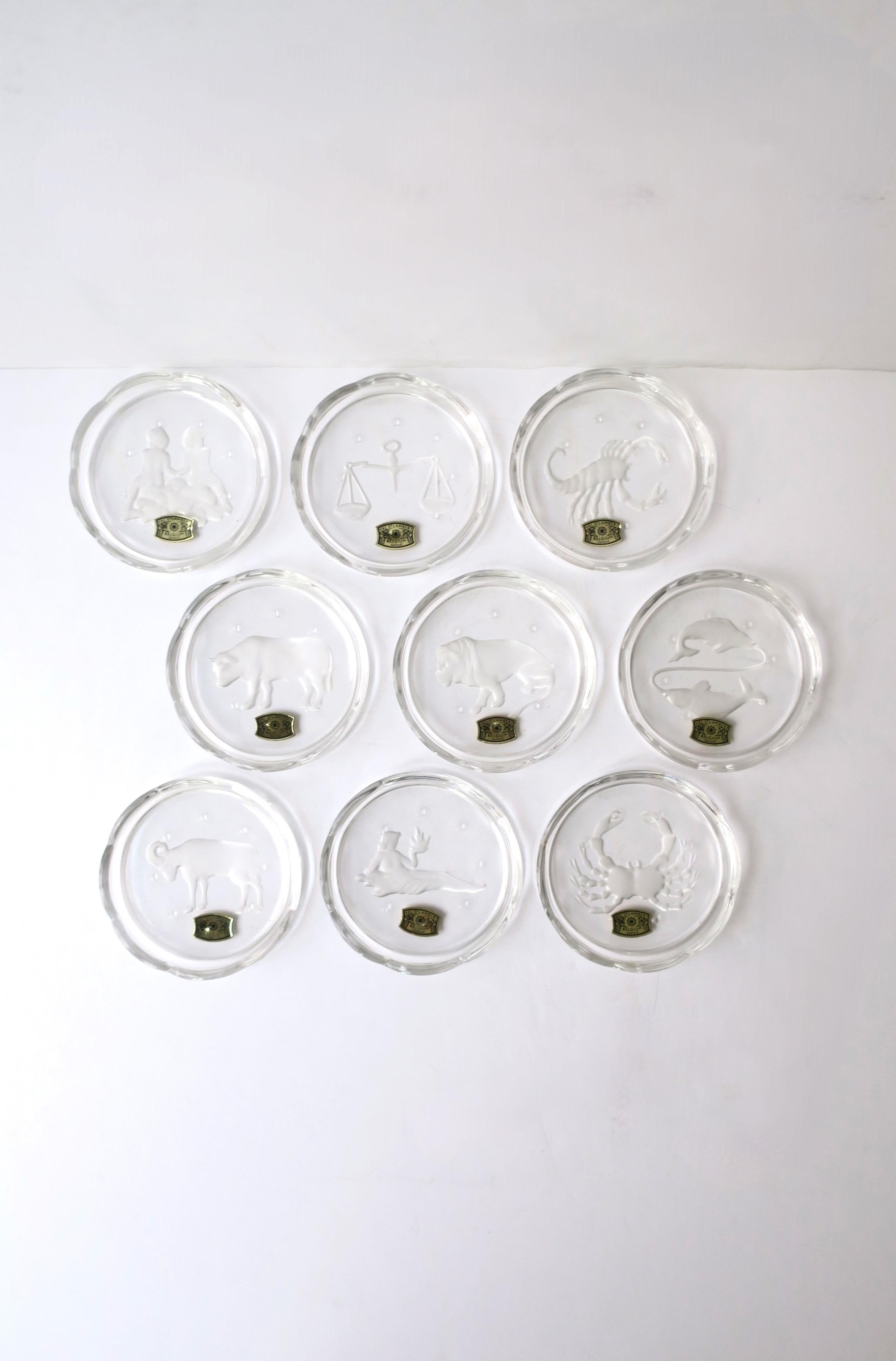 A beautiful set of nine (9) Belgian crystal 'zodiac' cocktail or drinks coasters with scalloped edge, from luxury Maison, Val Saint Lambert, circa early to mid-20th century, Belgium. A beautiful set of nine (9) crystal coasters with zodiac sign