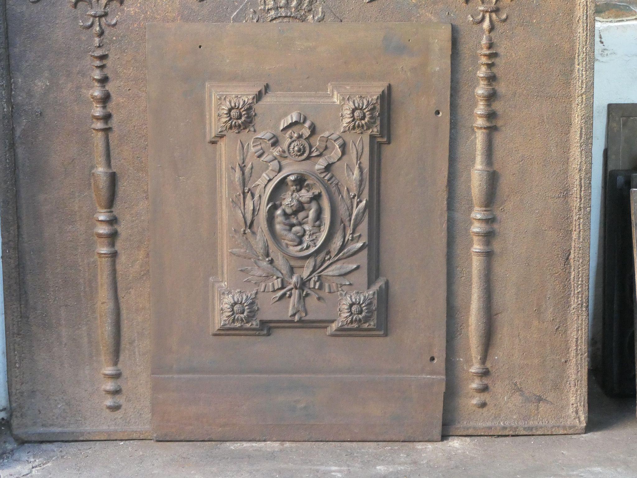 Belgian Victorian fireback with three cupids. The fireback is made of cast iron and has a natural brown patina. Upon request it can be made black / pewter at no extra cost. It is in a good condition, without cracks.