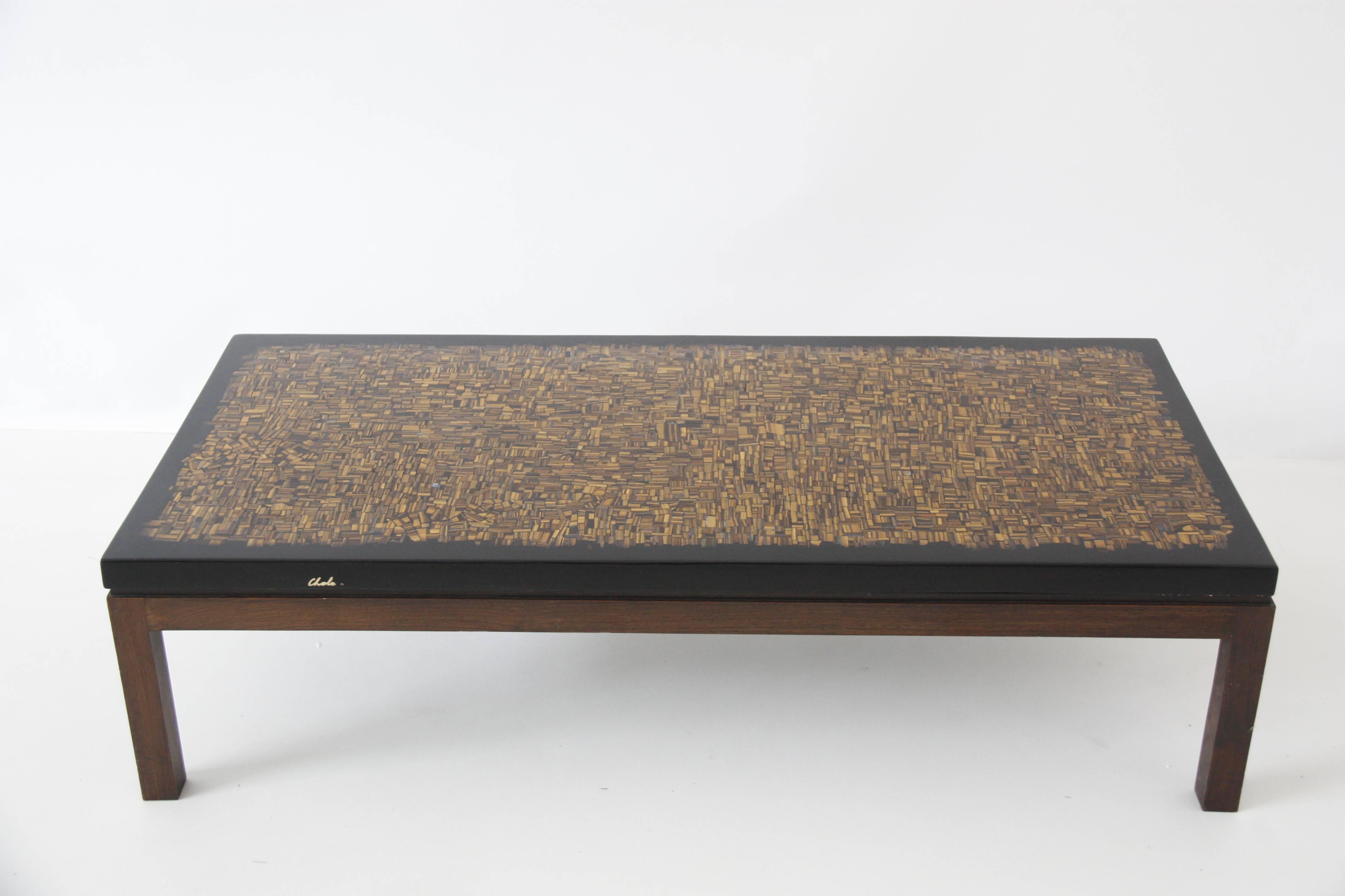 Vintage coffee table with inclusion of Oeil de Tigre into black resine, early piece with the base is in wood design by Ado Chale, Belgium, circa 1970
Measure: 60 cm x 130 cm ép. plateau 4cm
23.62
