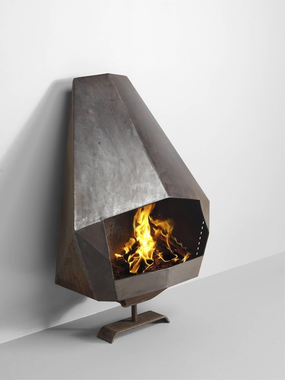 Fire place, steel, Belgium, 1980s.

Wall-mounted robust fire place in black coated steel. The diamond shaped body and pipe with a rectangular hearth. This clear, sharply edged shape of the pipe and hearth make this piece a distinct piece in every
