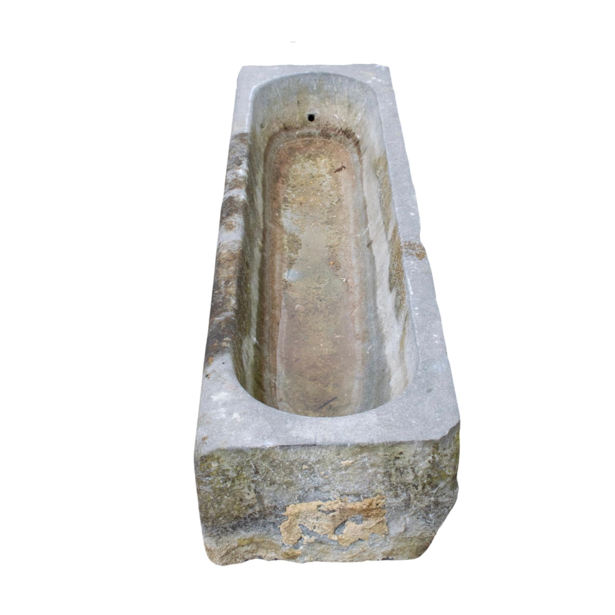 This Belgium Bluestone Trough is a unique piece crafted from 17th century Belgium bluestone. Its one basin is hand-carved from the original stone, providing durability and authenticity. The classic Belgian bluestone adds a sense of timeless style to