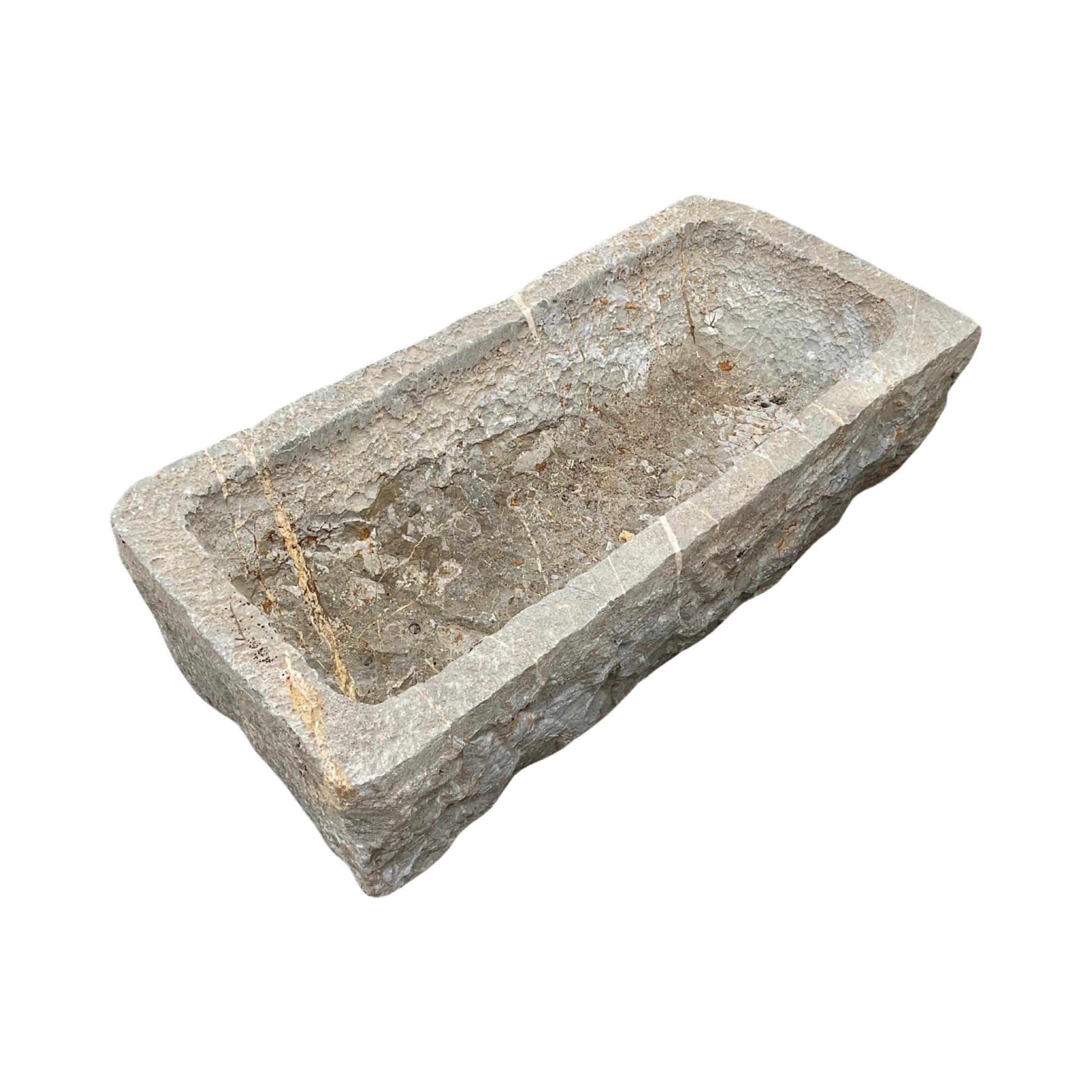 This small 18th century trough, crafted from authentic Belgian bluestone, adds a touch of antique charm to any space. Its unique style and rich history make it a one-of-a-kind piece with undeniable character. Perfect for adding an elegant touch to