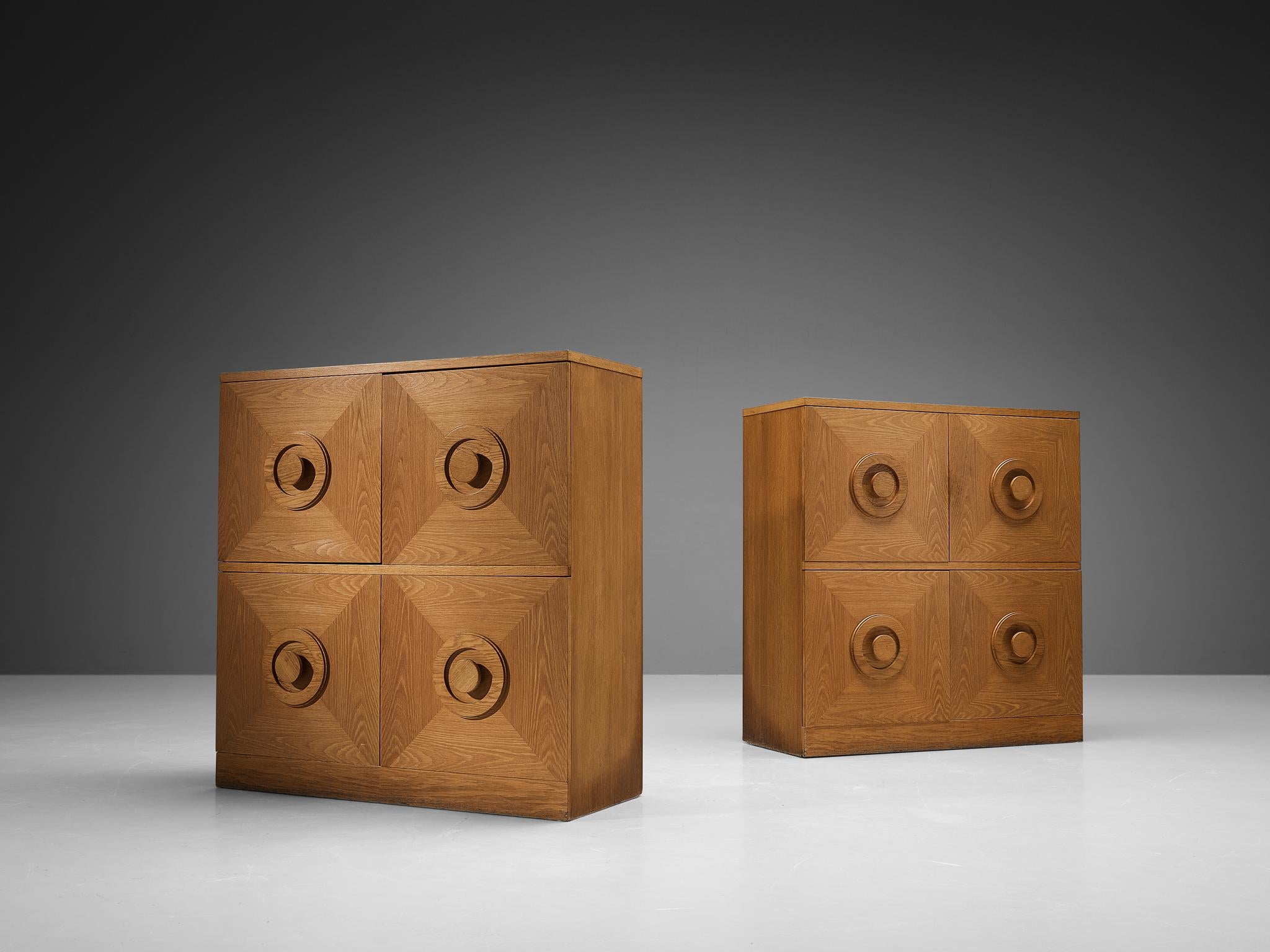 Pair of highboards, stained oak, Belgium, 1970s. 

This very evocative cupboard features a clear rhythm and flow established by means of well thought through lay out that is utterly well-balanced. The round doorknobs immediately catches the eye