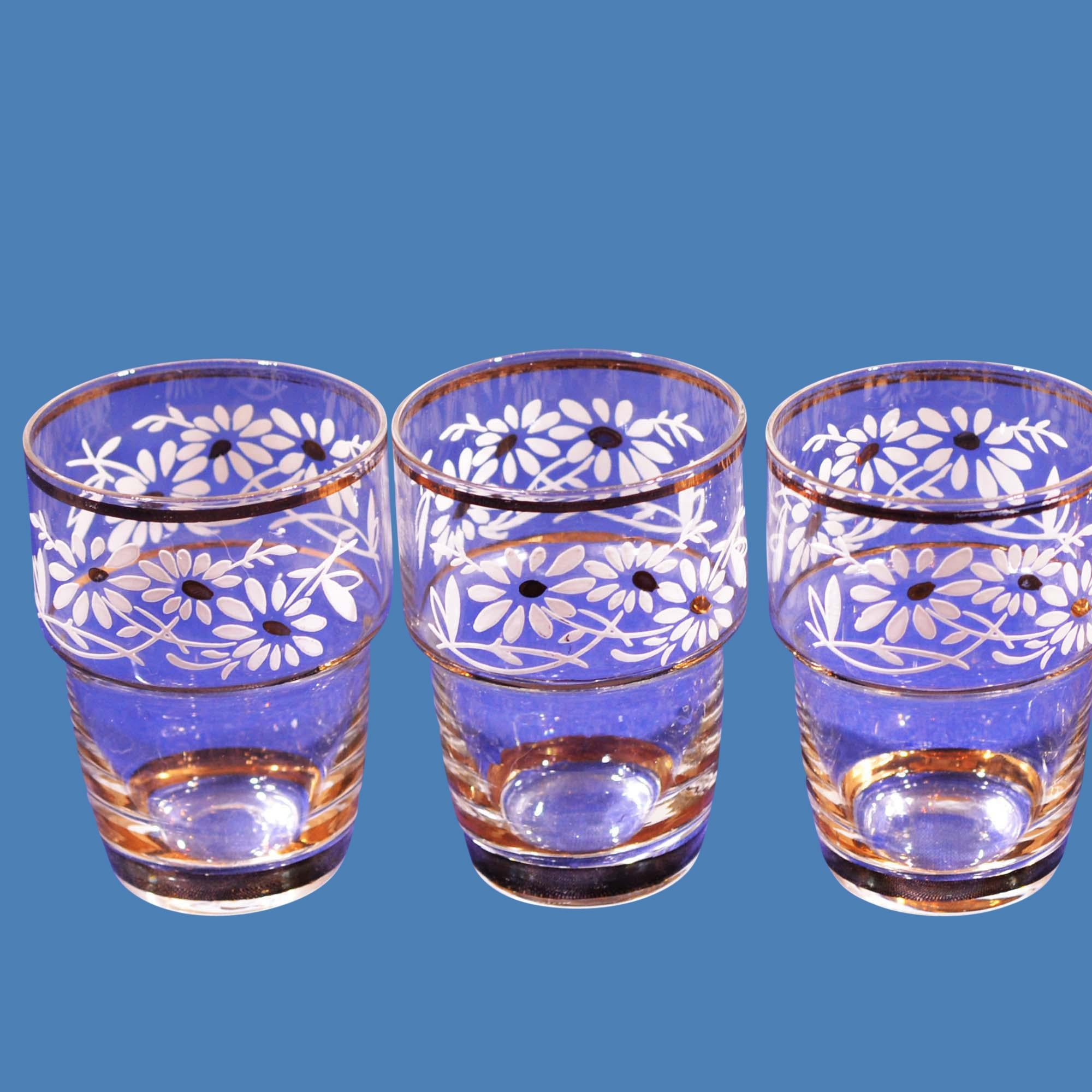 International gift of the month set of six small liquor glasses are fine examples of hand blown Belgium glass with hand painted floral design and decorated with 24-karat gold.