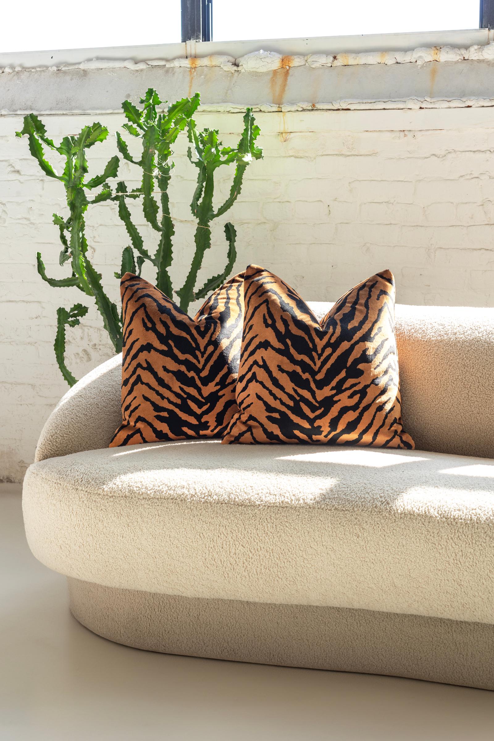 Hand crafted in Chicago, these Belgium velvet throw pillows redefine luxury with their plush texture and striking tiger design. The premium velvet, known for its unparalleled softness, wraps each down pillow on both sides in a layer of unmatched