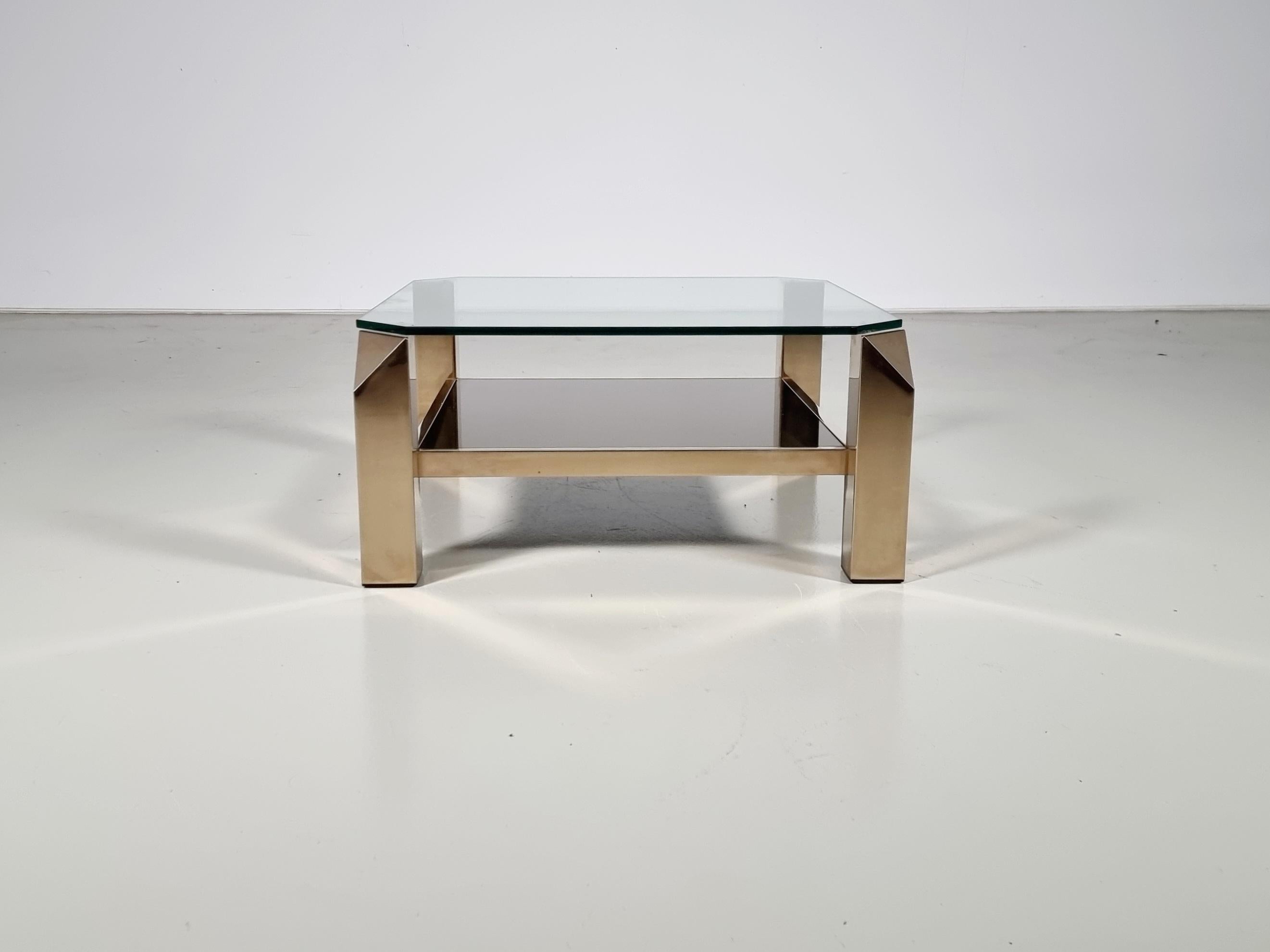 23-karat gold plated cocktail table in eye-catching geometric style, manufactured by Belgo Chrom in Belgium around 1970.

It is made of high-quality brass with a gold-plated finish. The finish to the square shapes of the base is really nice, with