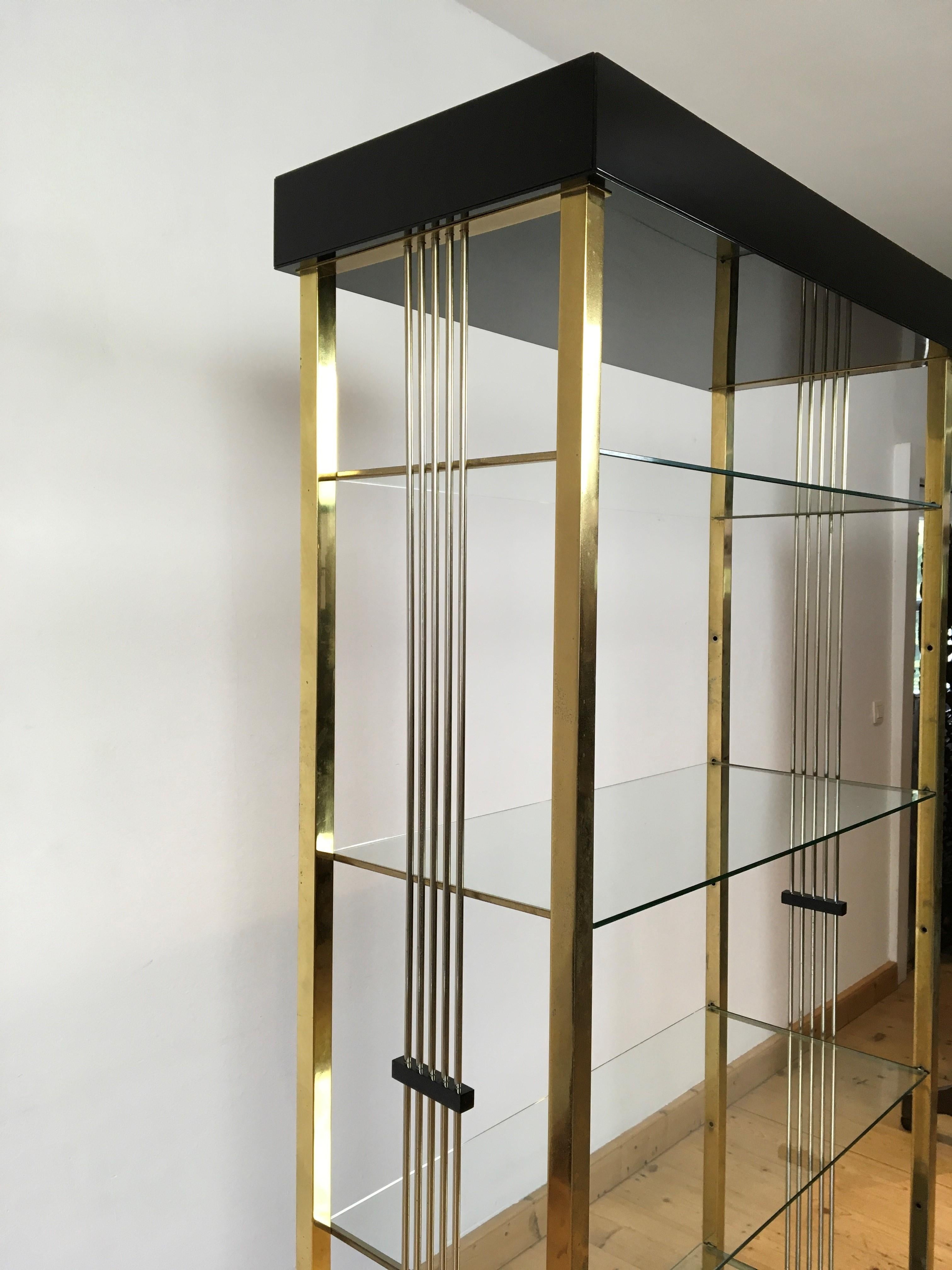 Belgo Chrome open showcase - open shelves - wall unit. 
A stylish black lacquered with gold-plated showcase. 
This model with bars on the side is fairly rare. 

This open showcase has 4 glass shelves included and 1 extra pair of brackets to