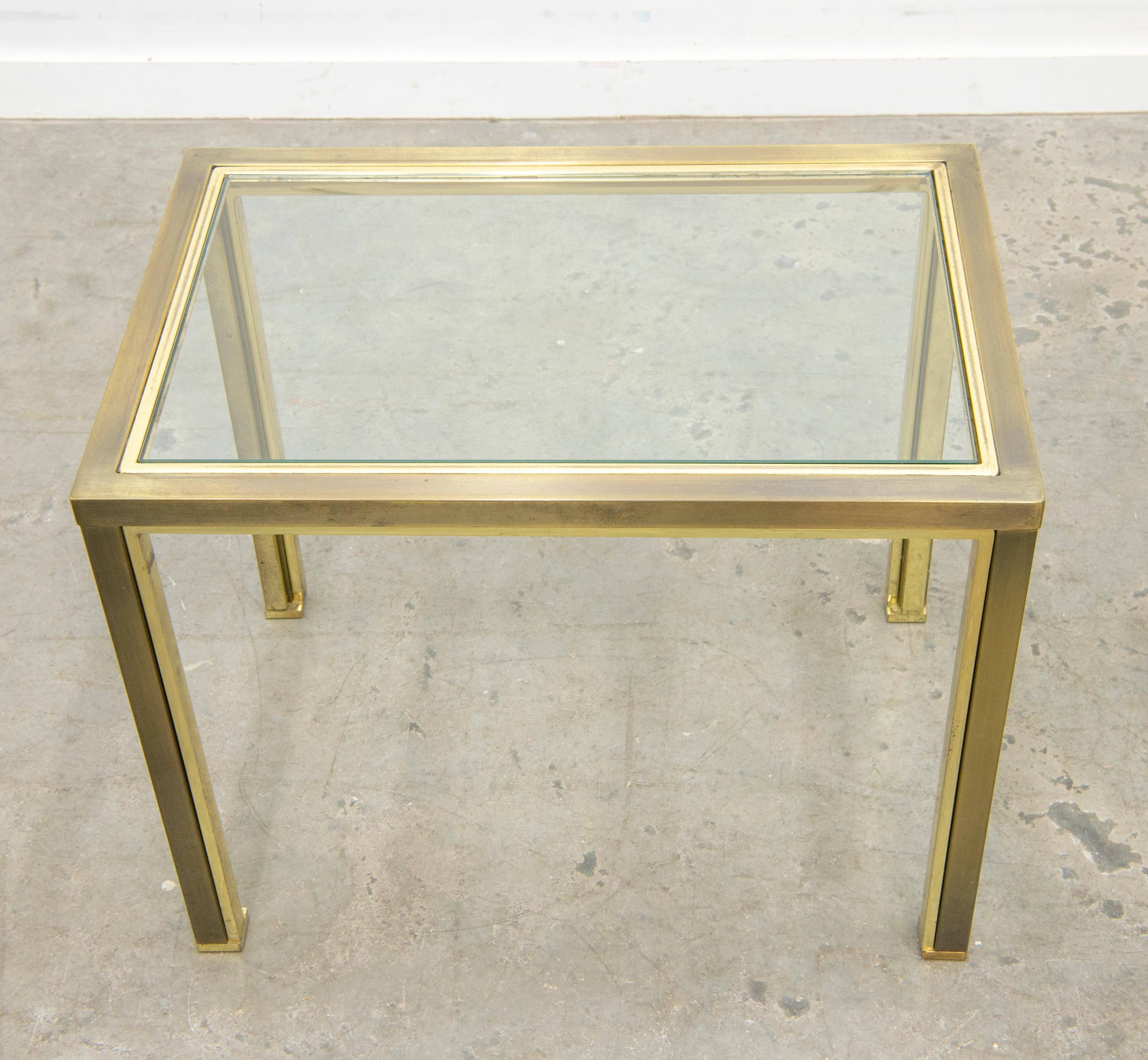 This table was made circa 1980 by Belgo Chrome in Belgium. It is made of a gold plated base in metal, with a glass top. The glass is see-trough. The frame is in overall good condition with use marks on it. There are some spots where the gold-plating