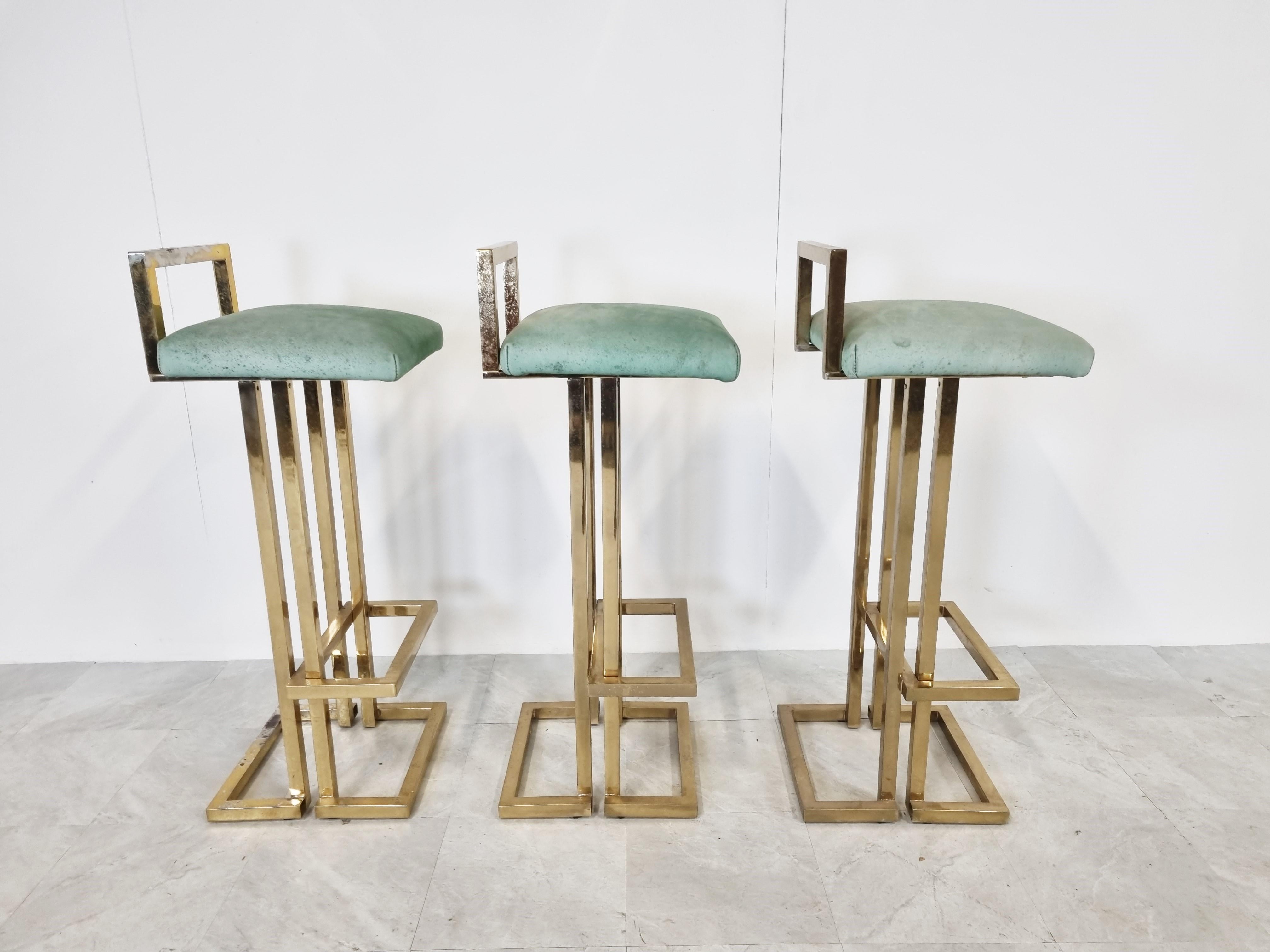 Beautiful brass bar stools by Belgochrom.

Beautiful timeless design with a luxury appeal.

They have their original green alcantara upholstery.

Condition: - Two stools are in good original condition
 - The third stools has faded brass on