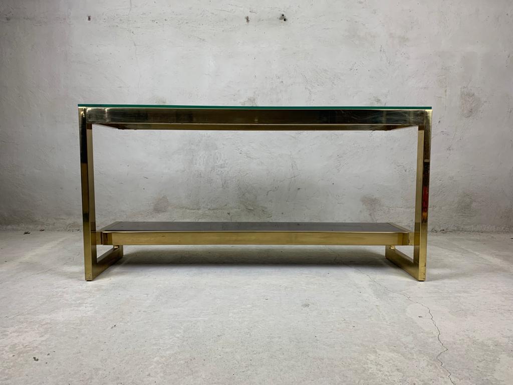 23kt gold layered 'G'-shaped console table produced by Belgochrom.

The table has mirrored and clear glass tops

Original condition with some wear on the brass, condition as picture. The glass is in good condition. Over the item look very