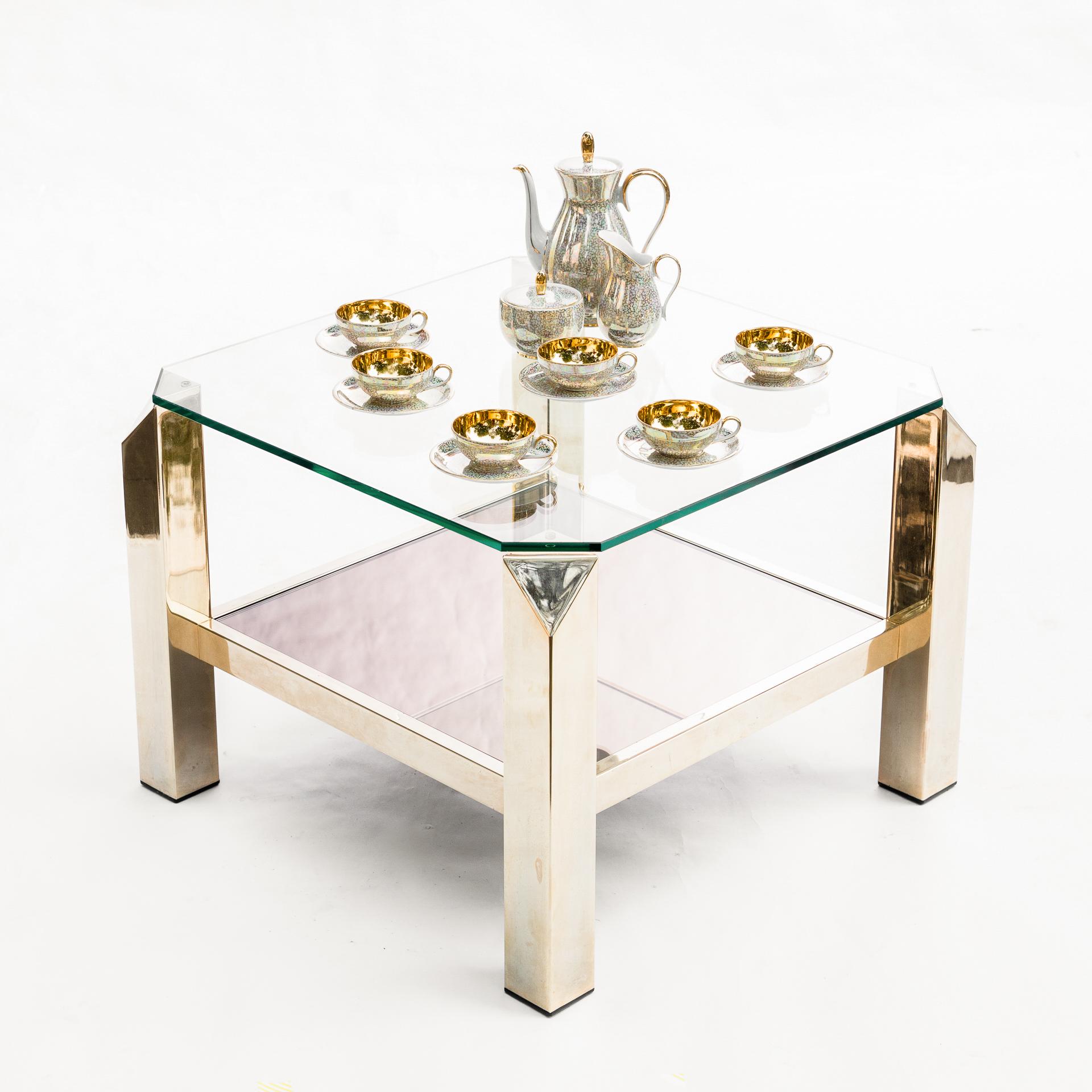 A unique coffee table made in Belgium in the Belgochrom manufacture. Noble material in the form of 23-carat gold covering the legs of the table is its main decoration.

 The Classic form varied with cut legs, thanks to which the design becomes