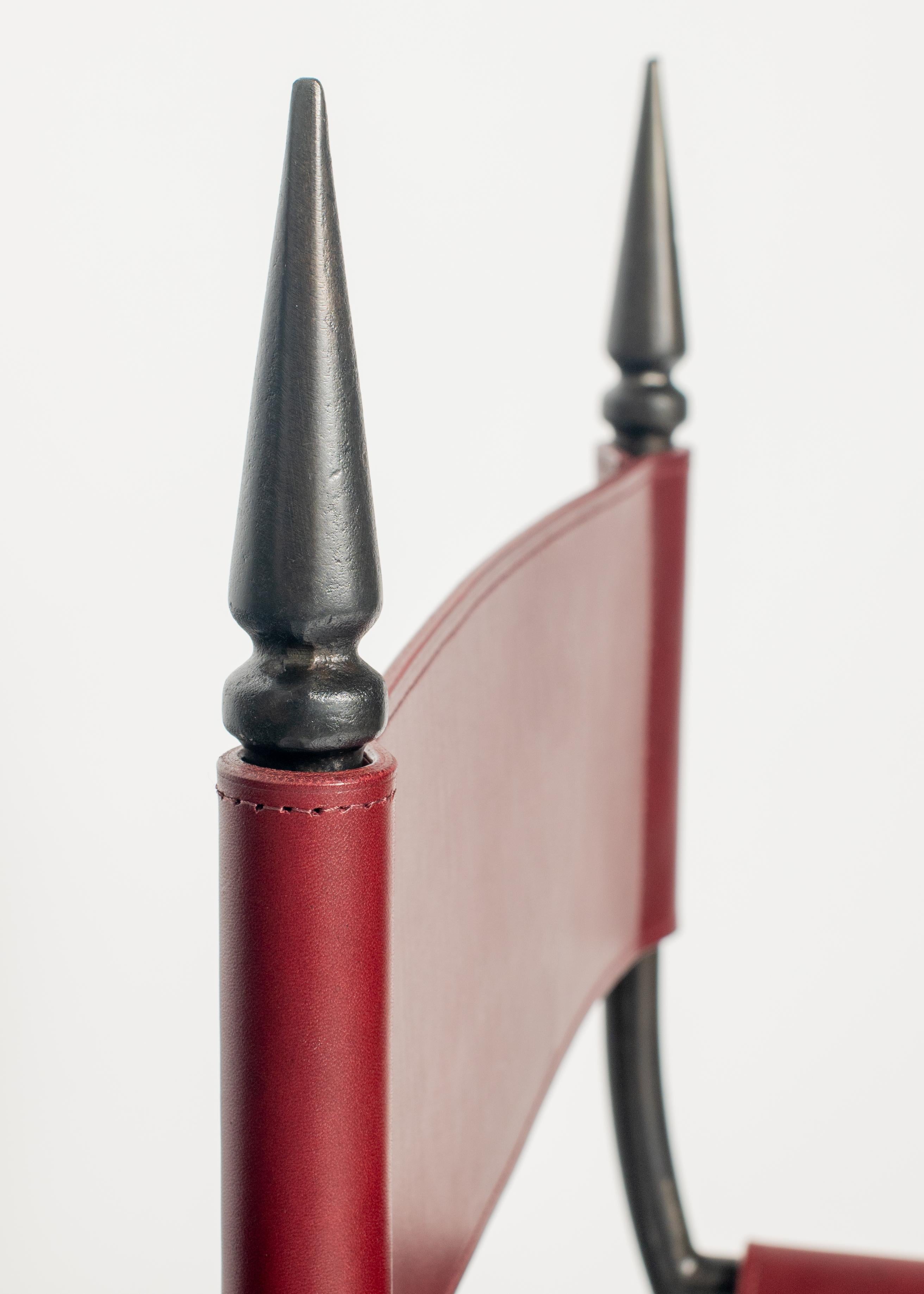 Our Belial Bar Stools subvert the intention of the classic Savonarola chair that was meant to demonize secular art and culture. By incorporating spikes, gothic arches, and oxblood leather, our version epitomizes beauty in its most nefarious