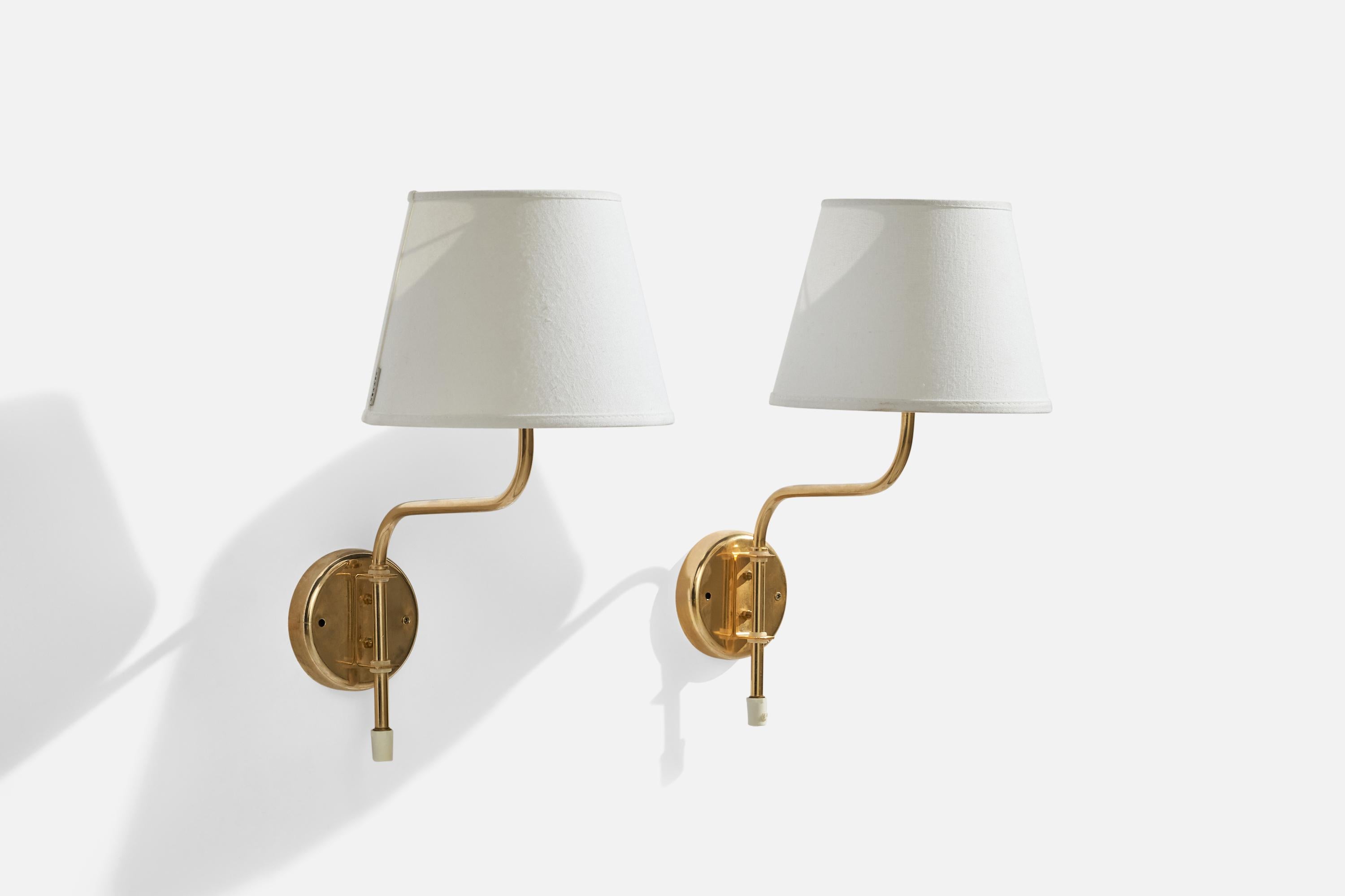 
A pair of adjustable brass and white fabric wall lights designed and produced by AB Belid, Sweden, 1970s.

Overall Dimensions (inches): 16”  H x 8” W x 11” D
Back Plate Dimensions (inches): 4” H x 4” W x .75” D
Bulb Specifications: E-26 Bulb
Number