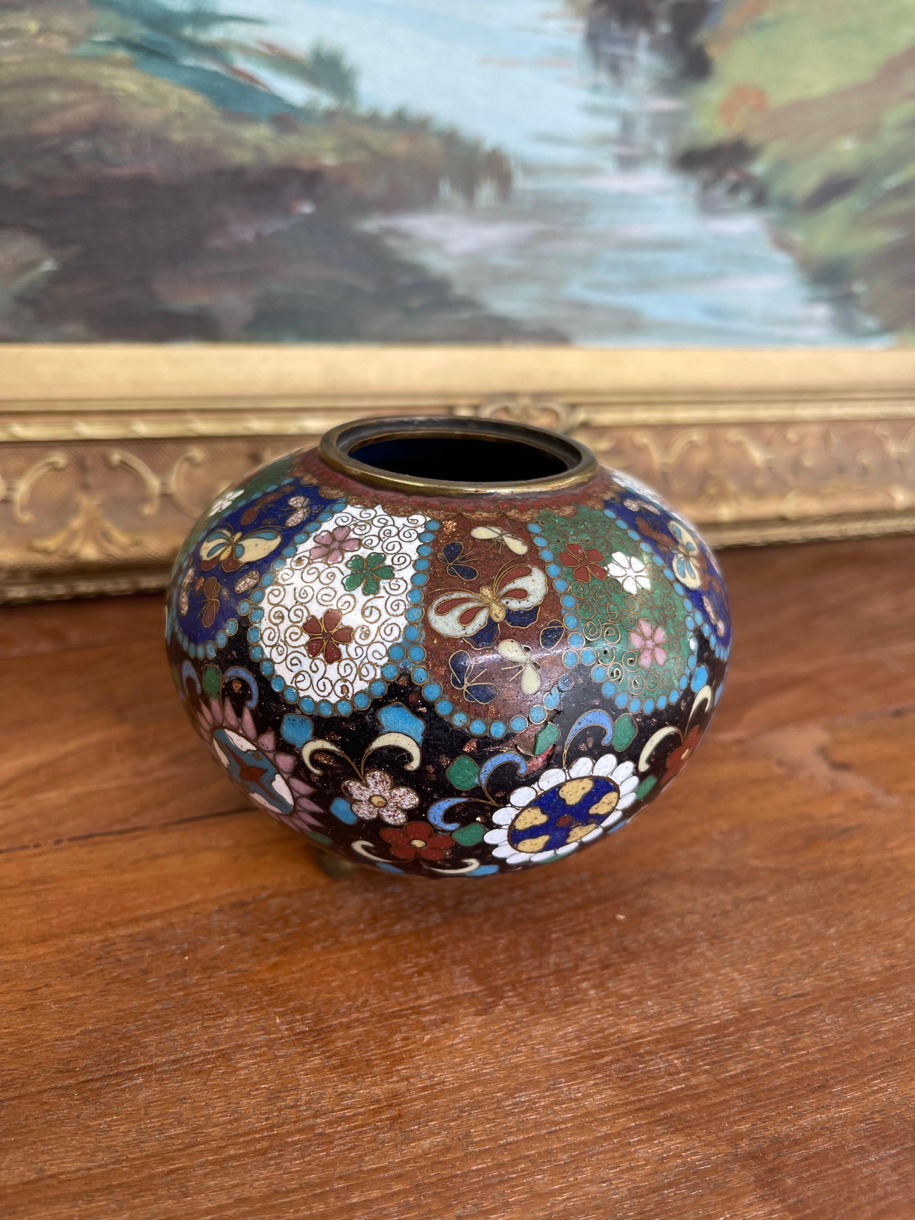  An exquisite early 20th century Chinese cloisonné miniature vase, showcasing meticulous craftsmanship and vibrant decorative detail.This bulbous-form vase is adorned with alternating panels of intricate floral motifs and butterflies, each section