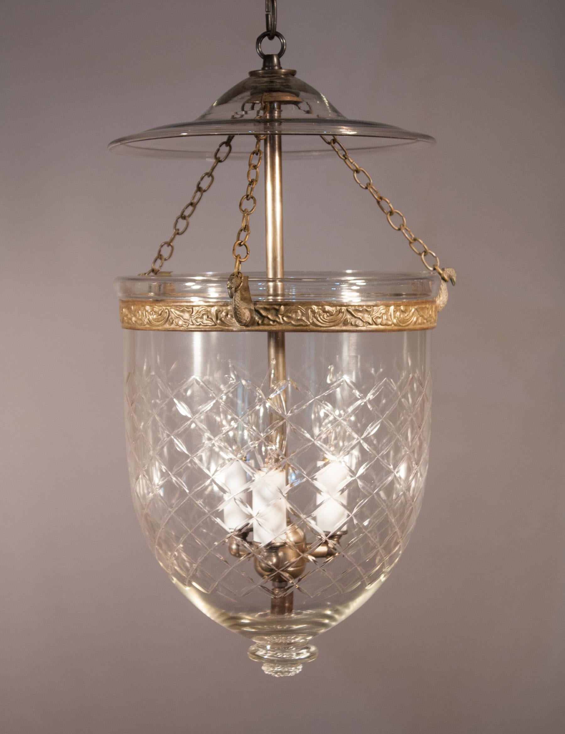 An authentic bell jar lantern with lovely form and an etched diamond motif. This circa 1890 lantern features excellent quality hand blown glass, with several visible air bubbles. The embossed brass band, which has a vine motif, has been replaced for