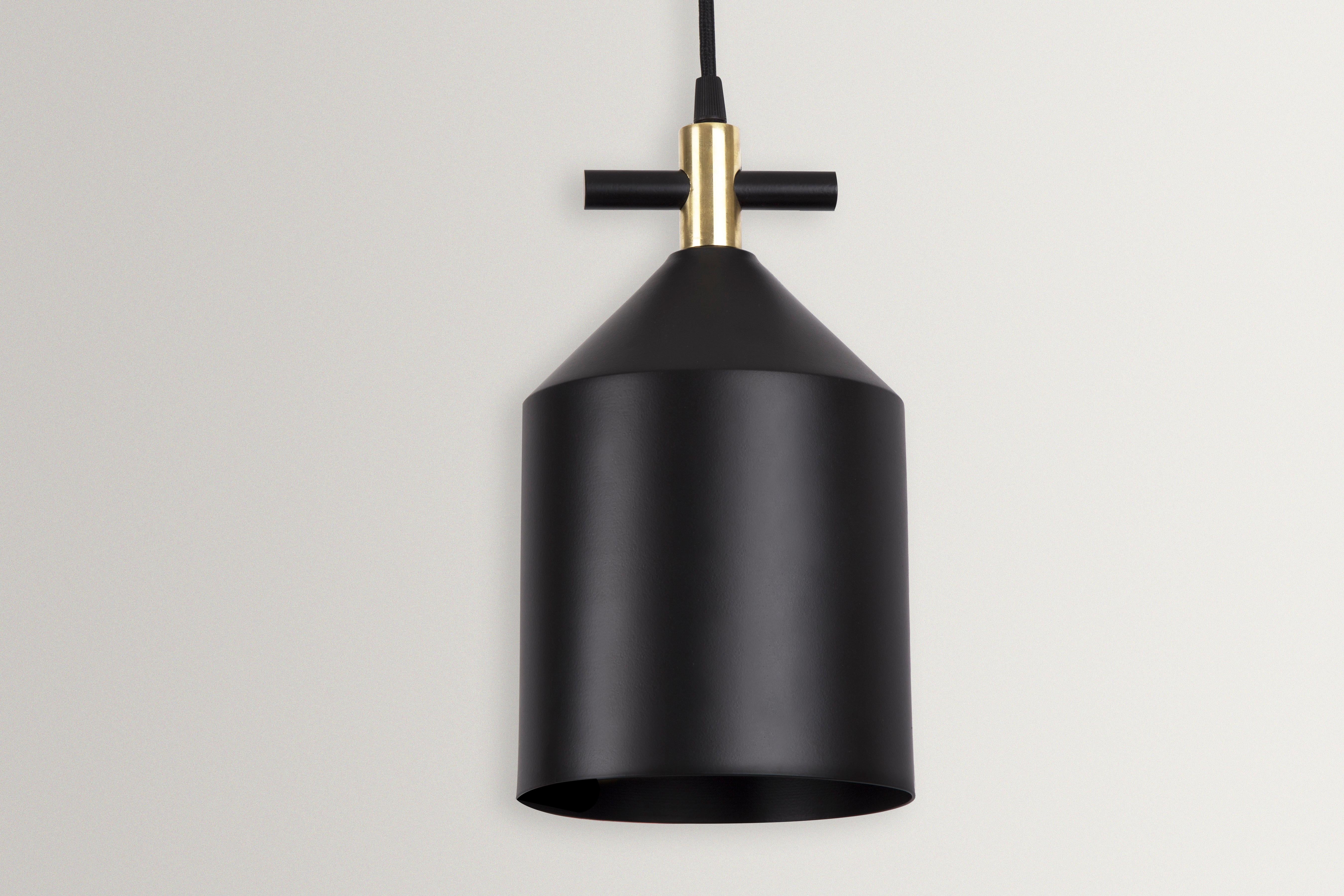 Bell pendant lamp in brass by Hatsu
Dimensions: W 15 x H 27 cm 
Materials: Powdercoated Aluminium, Brass Fabric Cord

Hatsu is a design studio based in Mumbai that creates modern lighting that are unique and immediately recognisable. We started