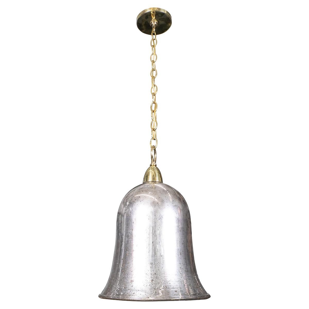 Bell-shaped glass pendant with distressed mercury finish and brass hardware.