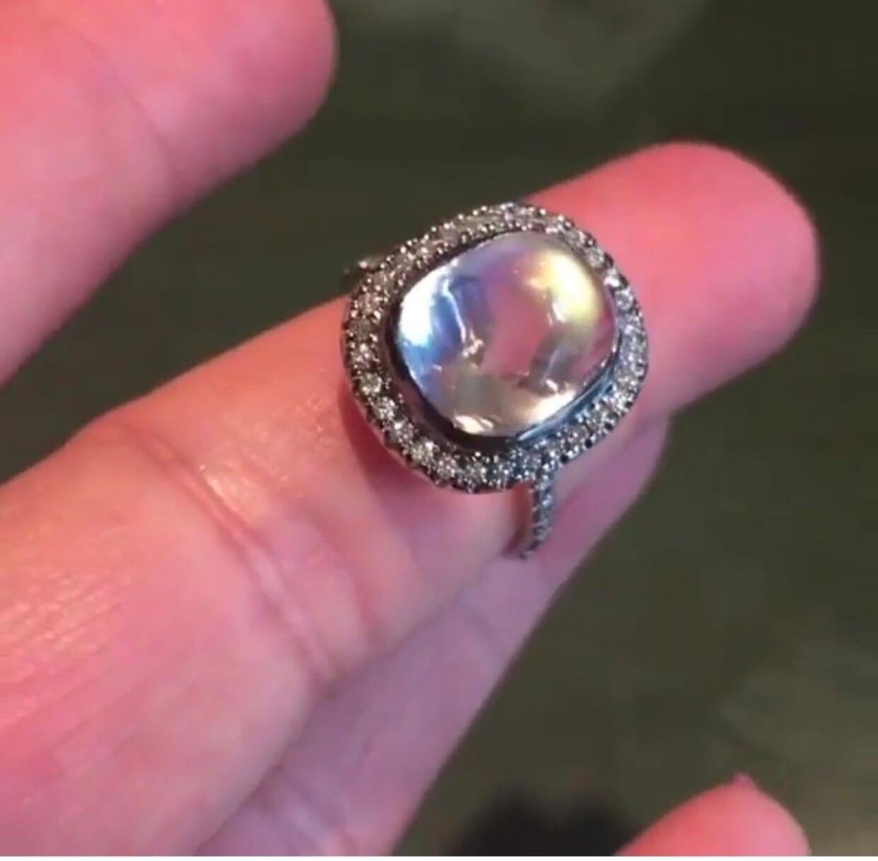 The  Statement Rainbow Moonstone Ring With Diamond Accent, Made with 18 K White Gold, And  Black Rhodium Plated. Moonstone Enhances Feminine Energy, Supporting Balance, Intuition And Good Judgment, Also Protects Travelers On Their  Journeys. The