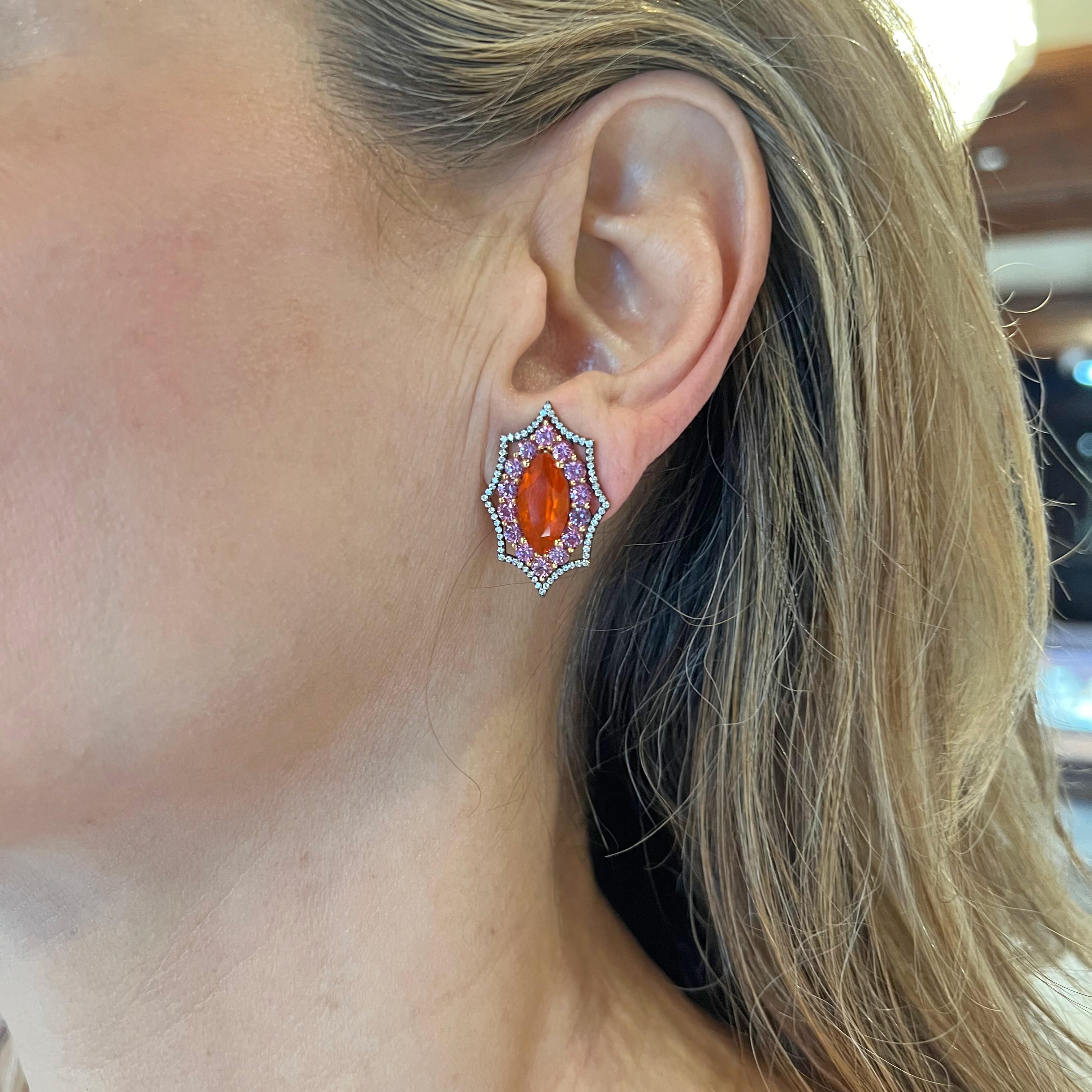 Multicolored gem-set earrings in 18k gold created by Bella Campbell- a part of the Campbellian Collection. Each centering a marquise-shaped Mexican fire opal surrounded by purplish-pink sapphires and round brilliant-cut diamonds.  Two fire opals