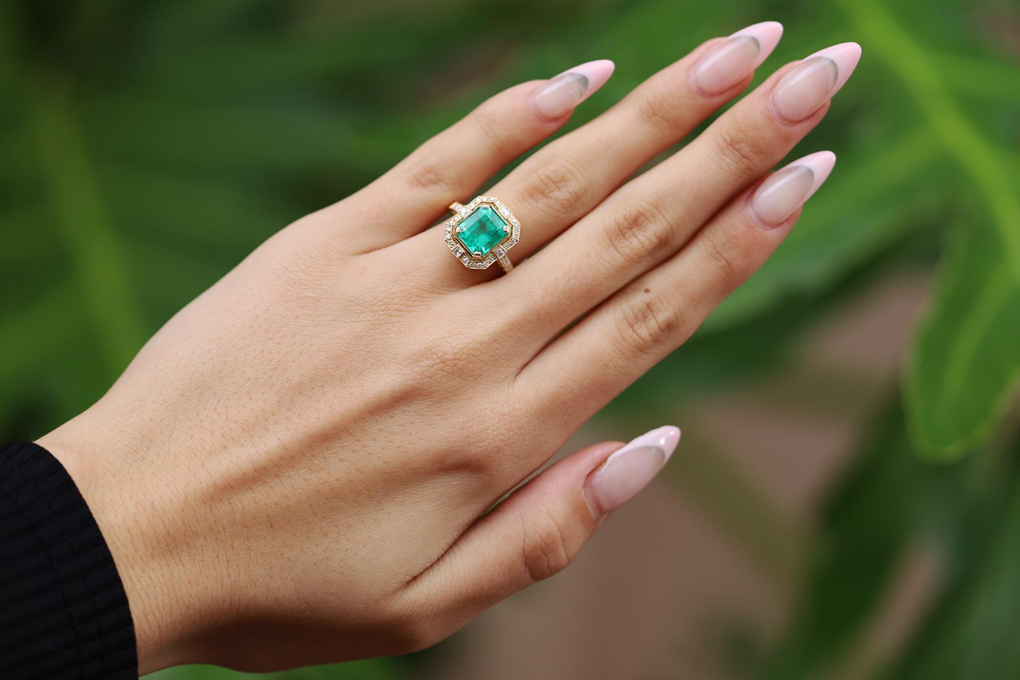 A classic, classy Colombian emerald ring centering upon a GIA certified 2.59 carat step cut beauty with a vibrant and verdant green color. Set in an 18k yellow gold Art Deco inspired mounting enhanced by old mine cut and French cut diamonds, all
