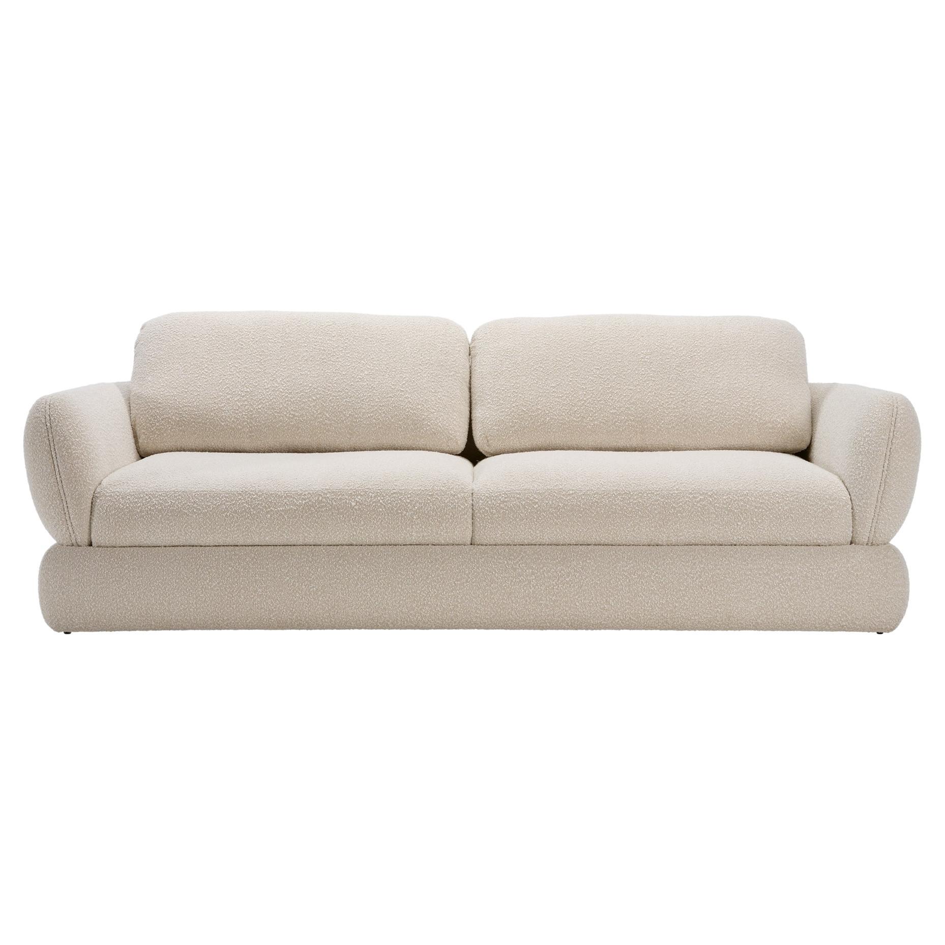 This sofa features a curved silhouette and round arms, softening your surrounding design scheme. A modern yet elegant addition to a living room, the sofa BELLAGIO is fully upholstered in a beautiful bouclé fabric.
Designed with a silhouette that