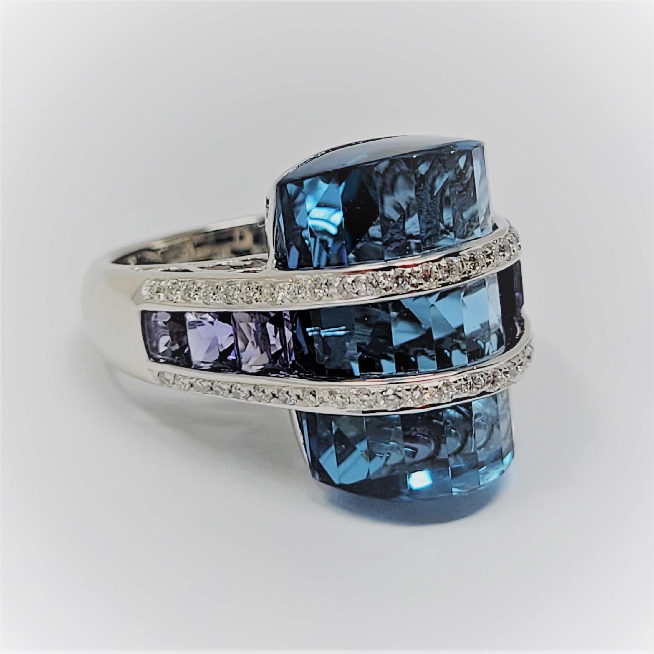 Bellarri blue topaz accented with iolite and diamonds in 18 karat white gold.  This ring is sure to please!