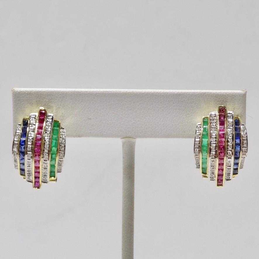 Do not miss out on these beautiful multicolor square cut multi stone diamond earrings circa 1970! 7 rows of stunning diamonds, emeralds, rubies and sapphires are contrasted by a glistening 18K yellow gold in a clip on style to create these glamorous