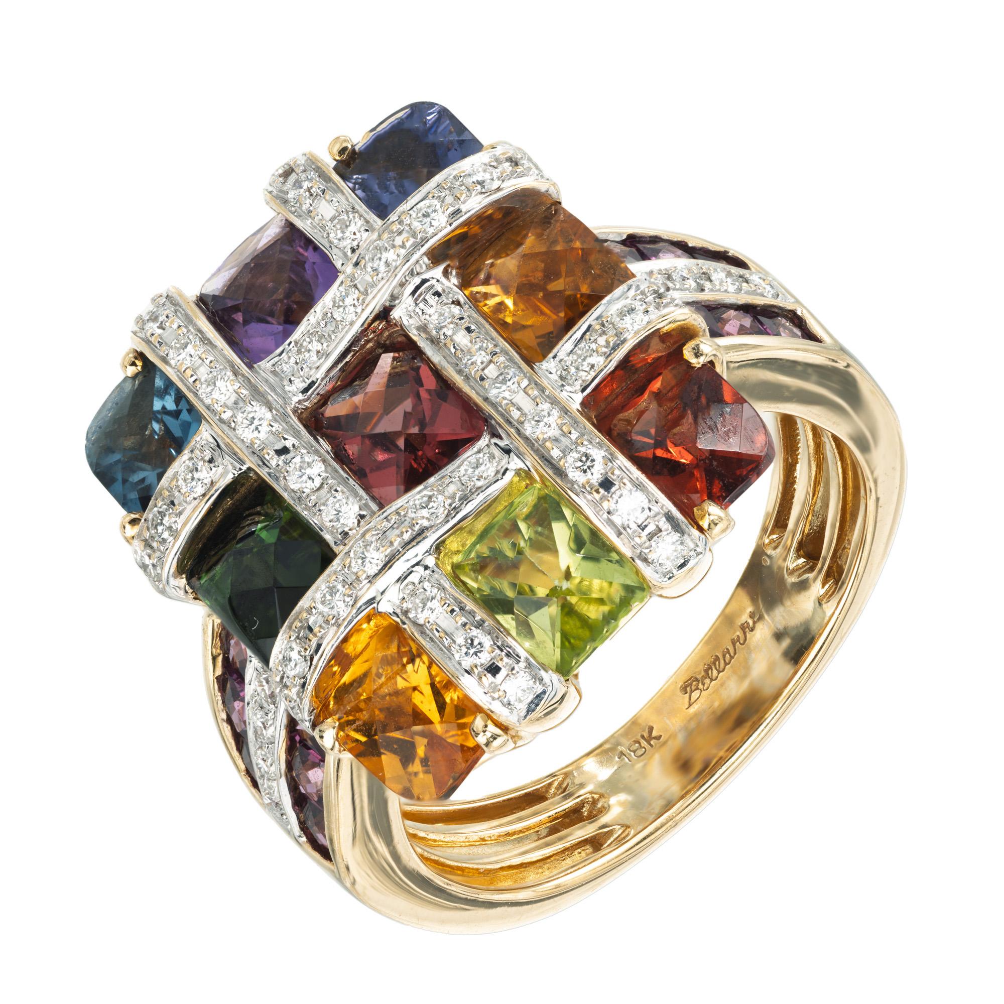 This Bellarri 4.68ct multi-color gemstone and diamond 18k yellow gold tic tac toe Mosaic Collection cocktail ring is a masterpiece of elegance. The vibrant hues of the amethyst, topaz, citrine, Iolite, tourmaline, garnet and peridot blend
